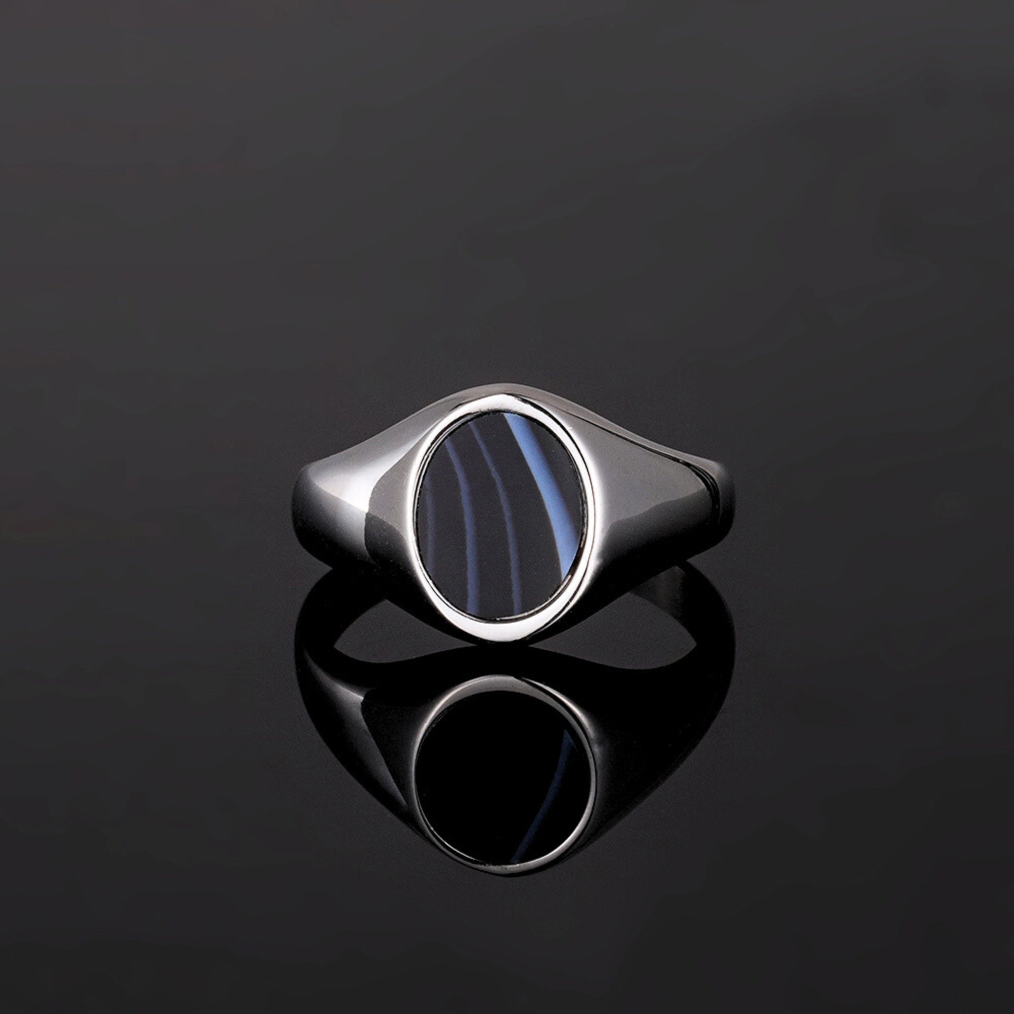 Silver ring with a blue stone on a black background
