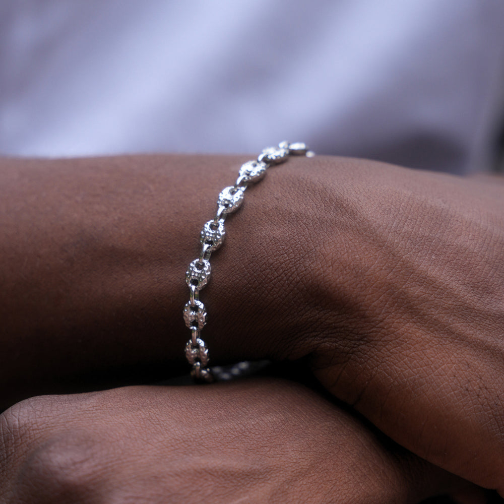 Silver bracelet on a wrist with a blurred background