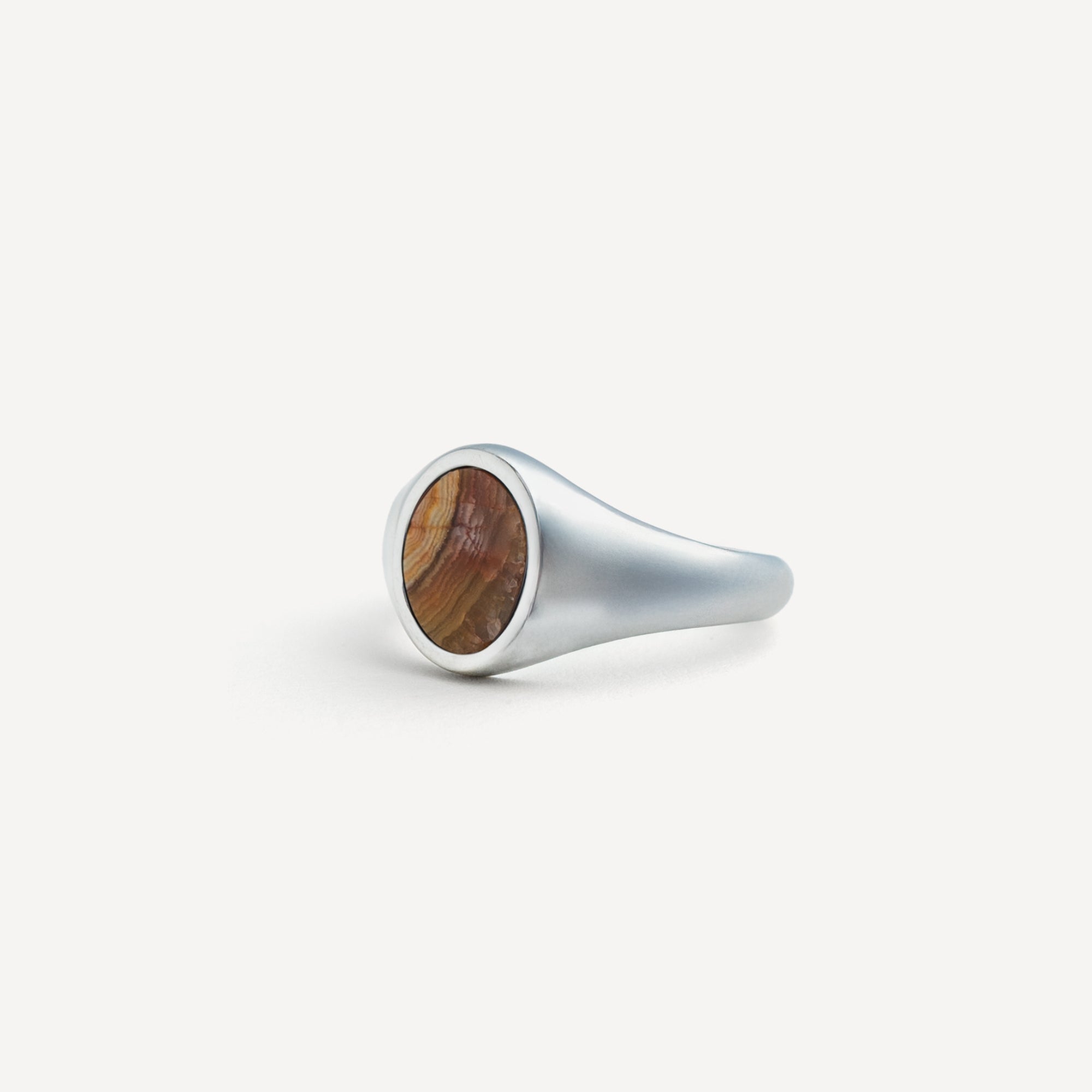 Silver ring with wooden inlay on a white background