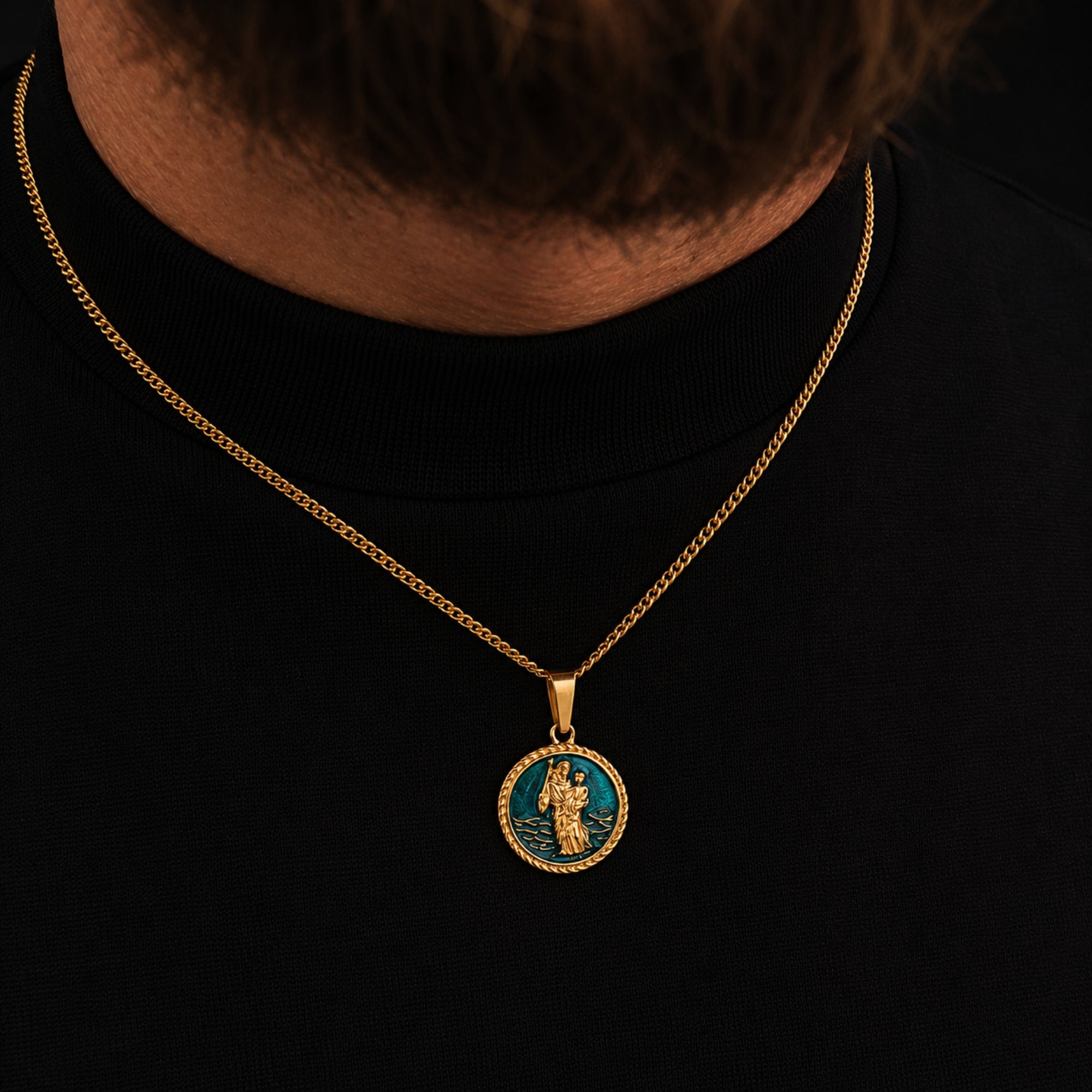 Gold necklace with a pendant on a black background