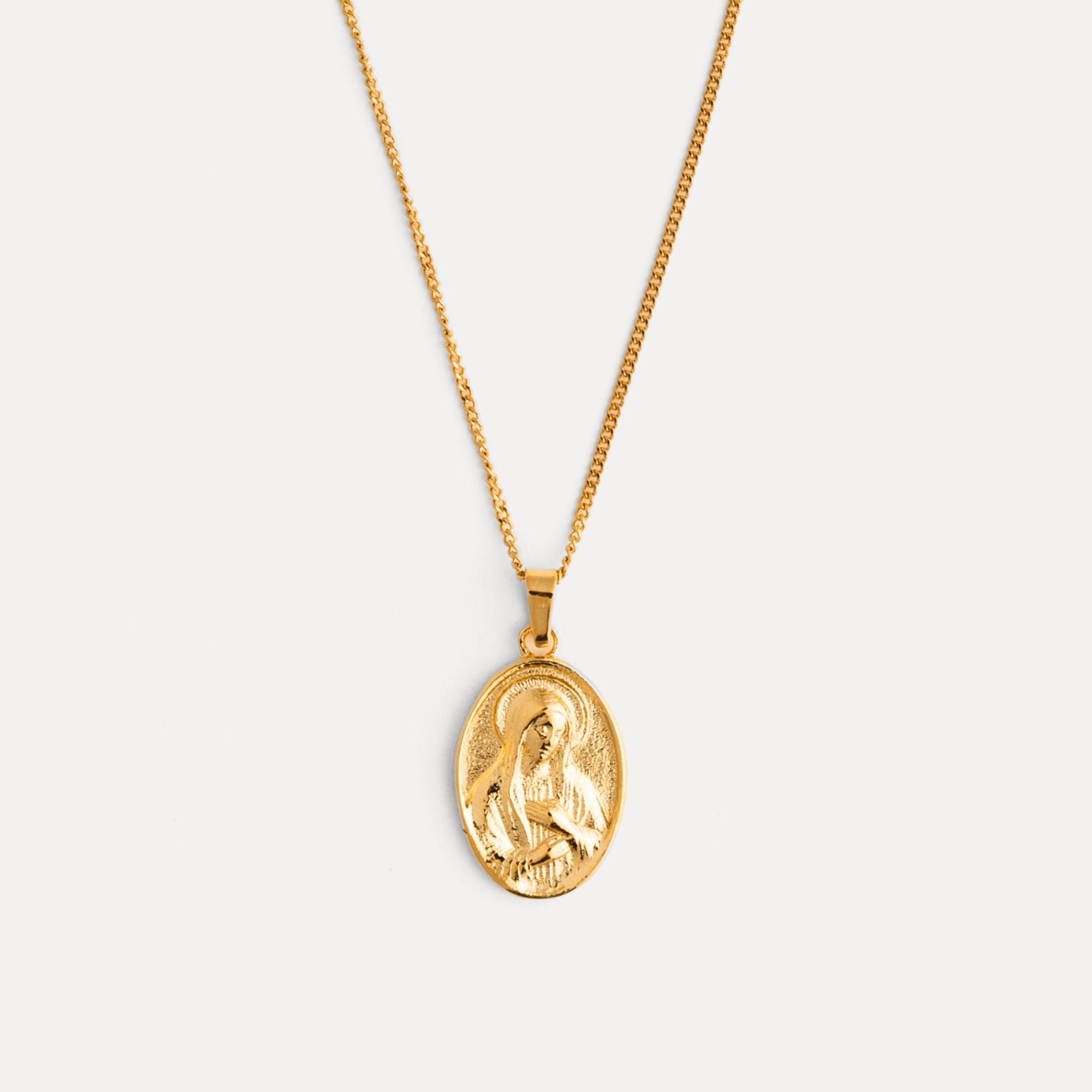 Gold necklace with a pendant on a white background