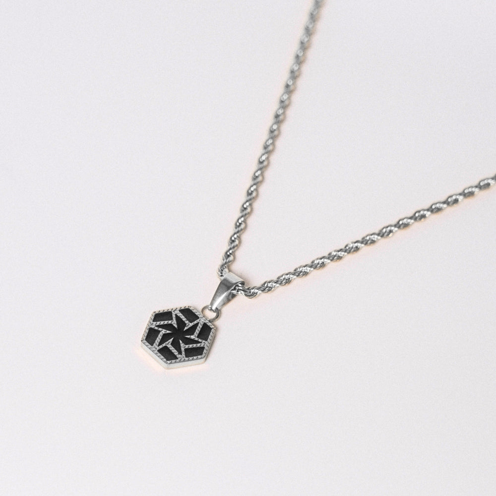 Necklace with a hexagonal pendant on a light gray background