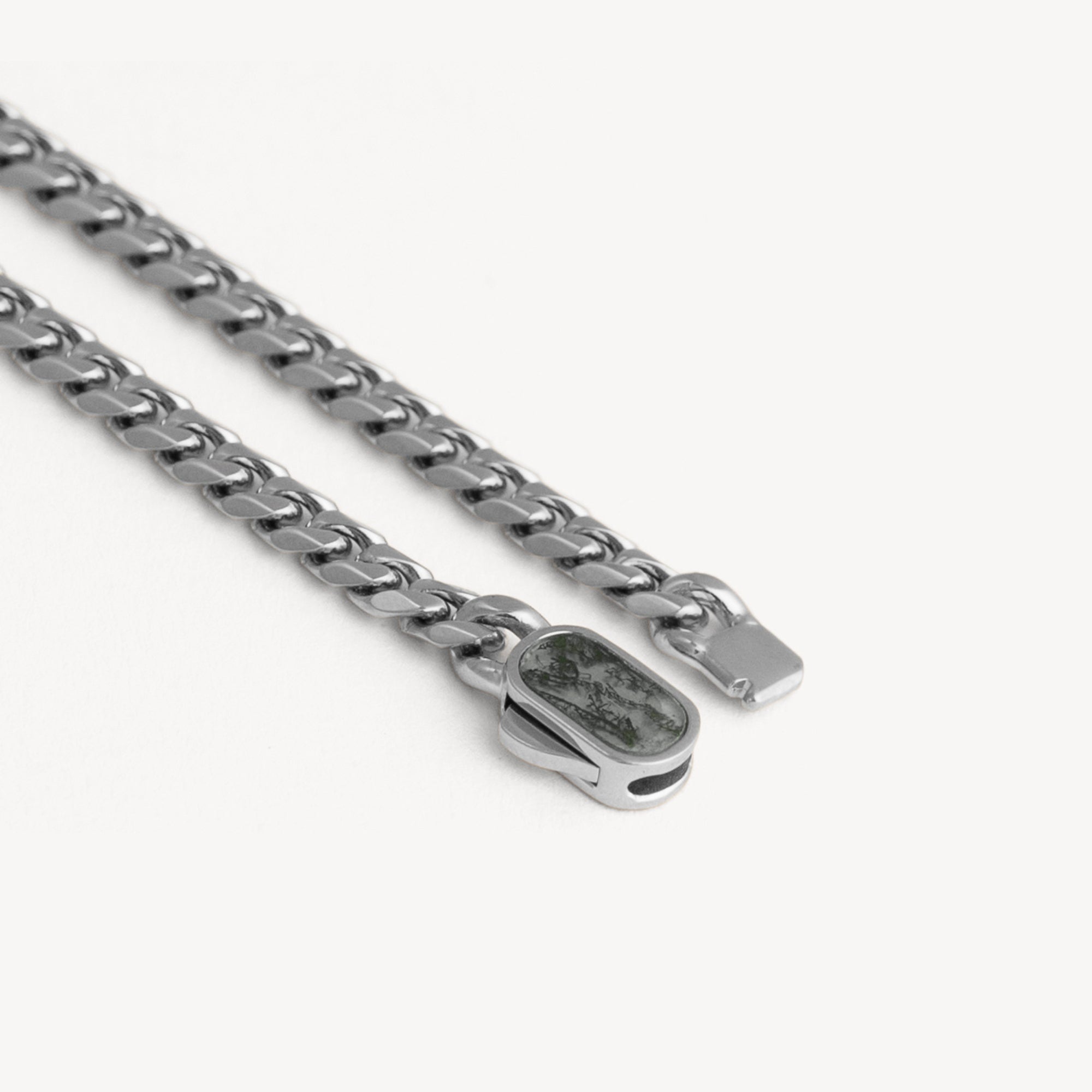 Silver chain necklace with a clasp on a white background