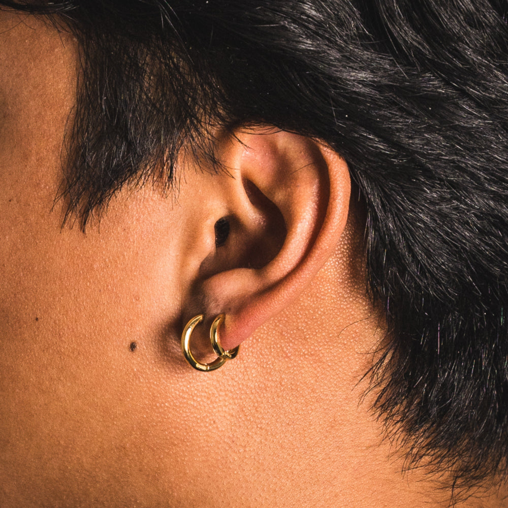 Close-up of an ear with a gold hoop earring