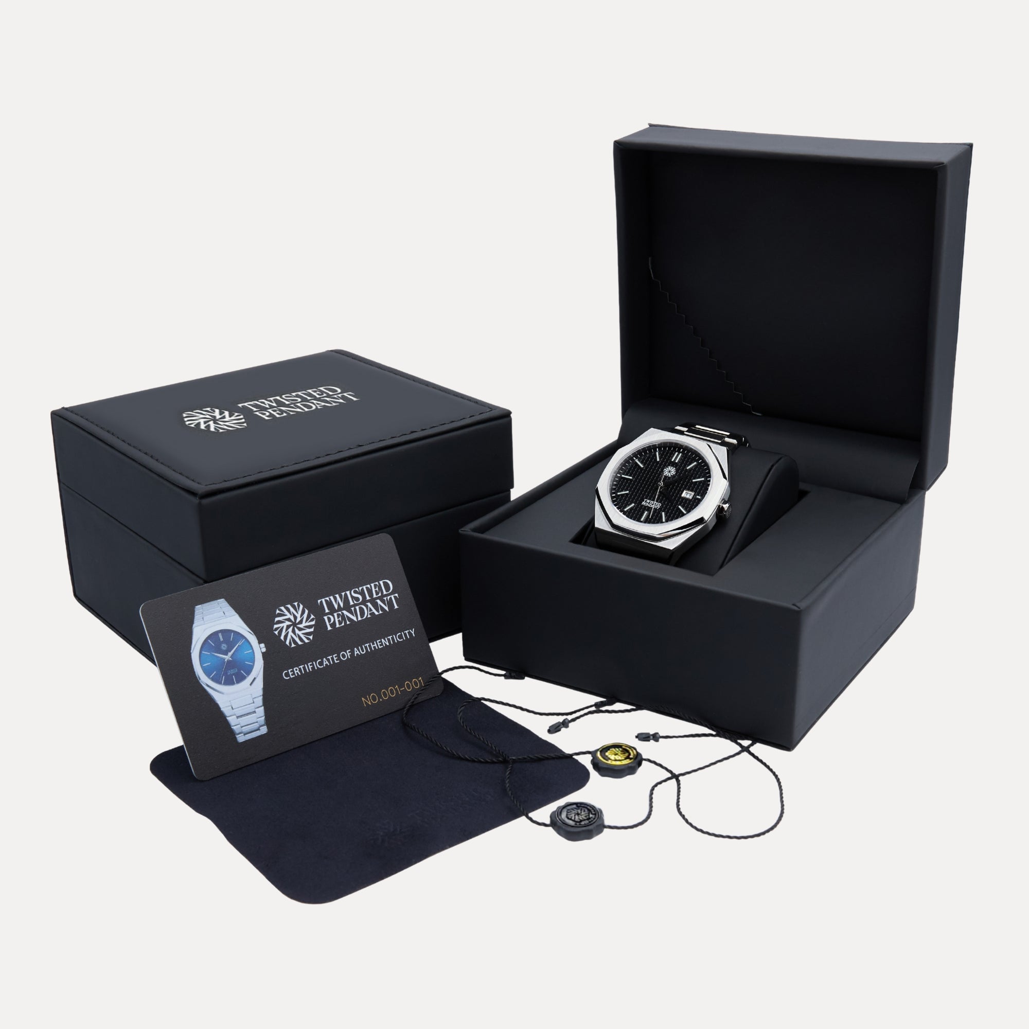 Black watch in an open box with a card and charging cable on a white background