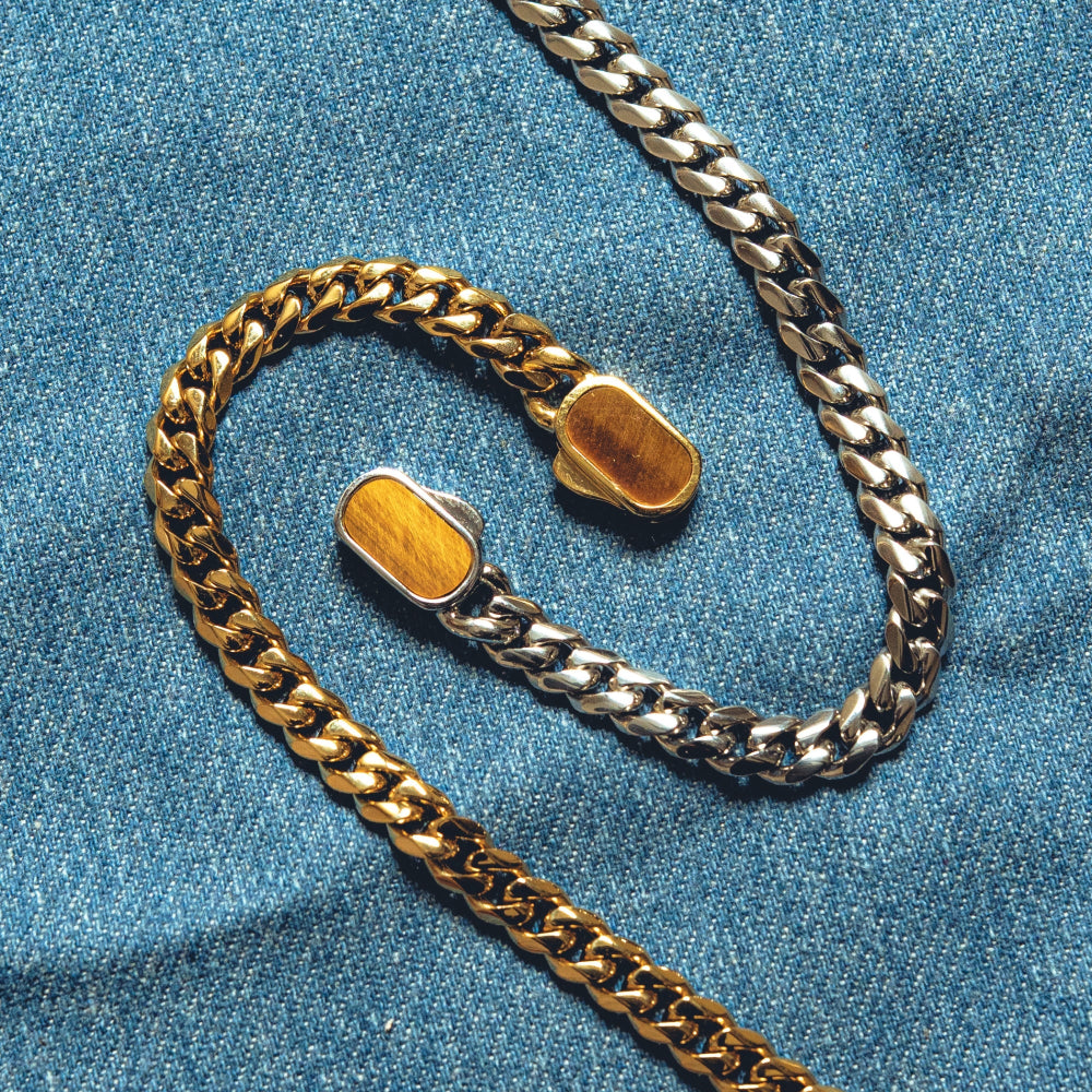 Gold and silver chain on a blue denim background