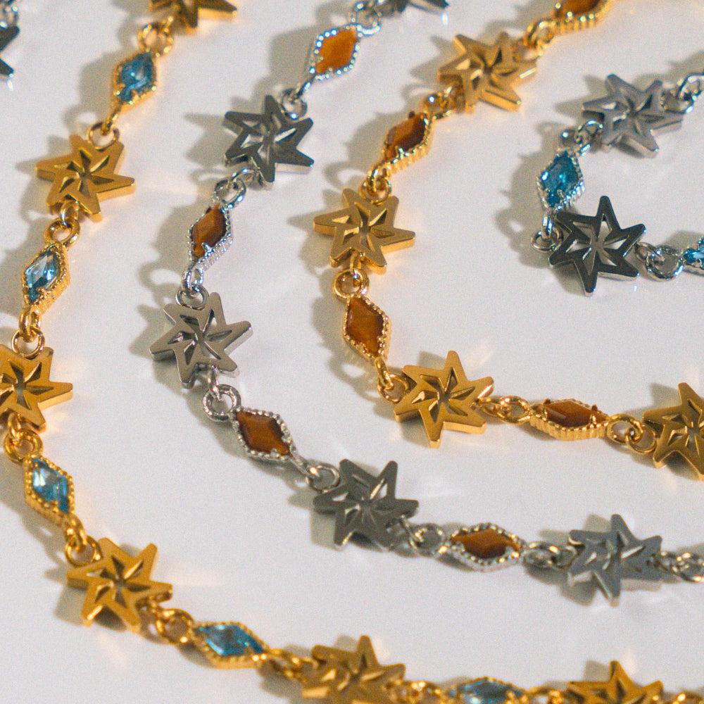 Gold, silver, and star-shaped jewelry on a white background