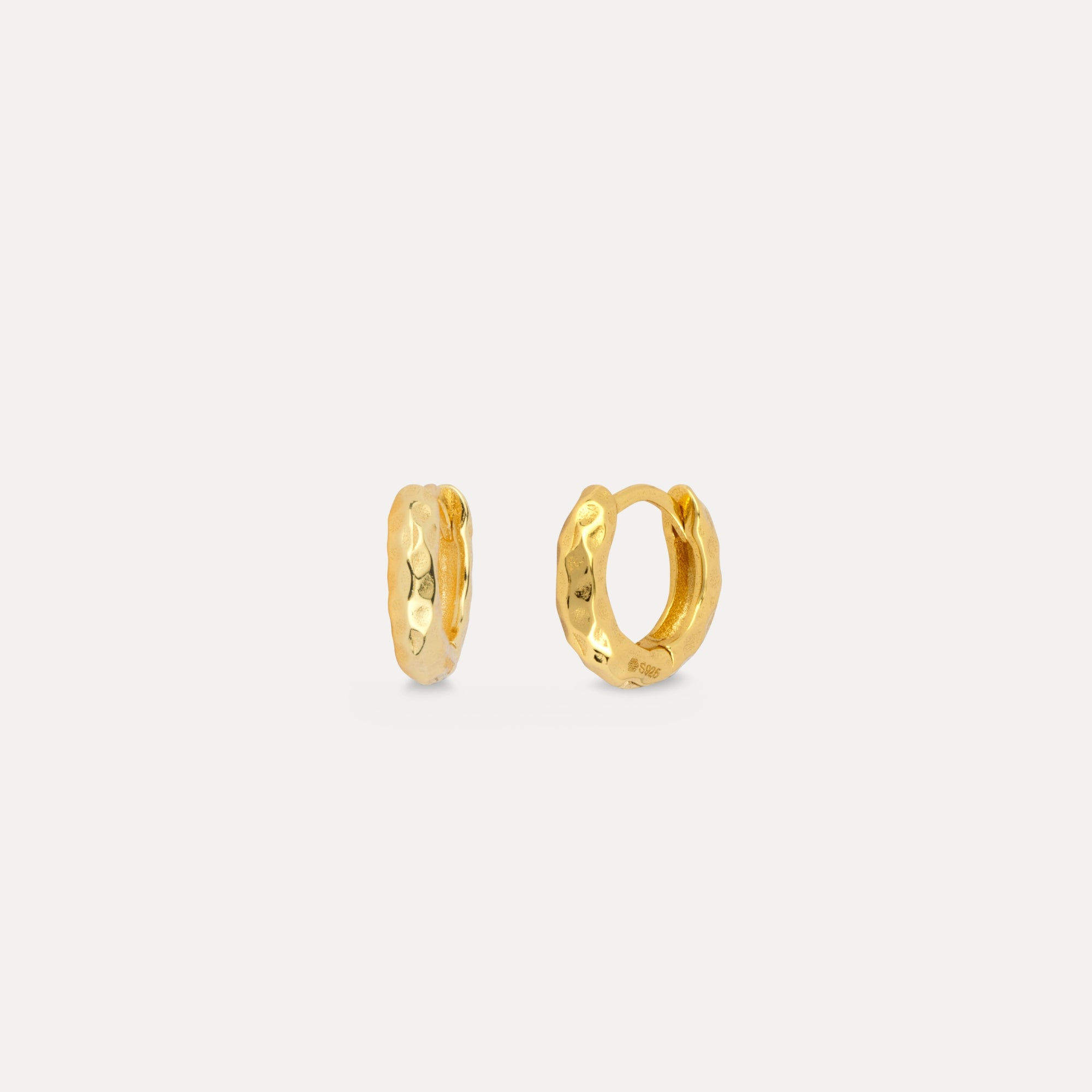 Pair of gold hoop earrings on a white background