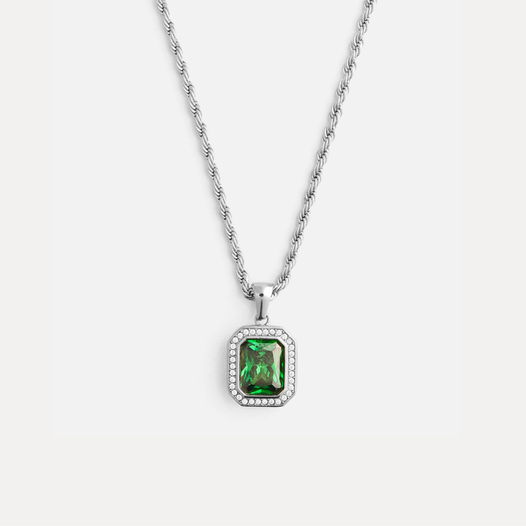 Necklace with a green gemstone pendant on a white background