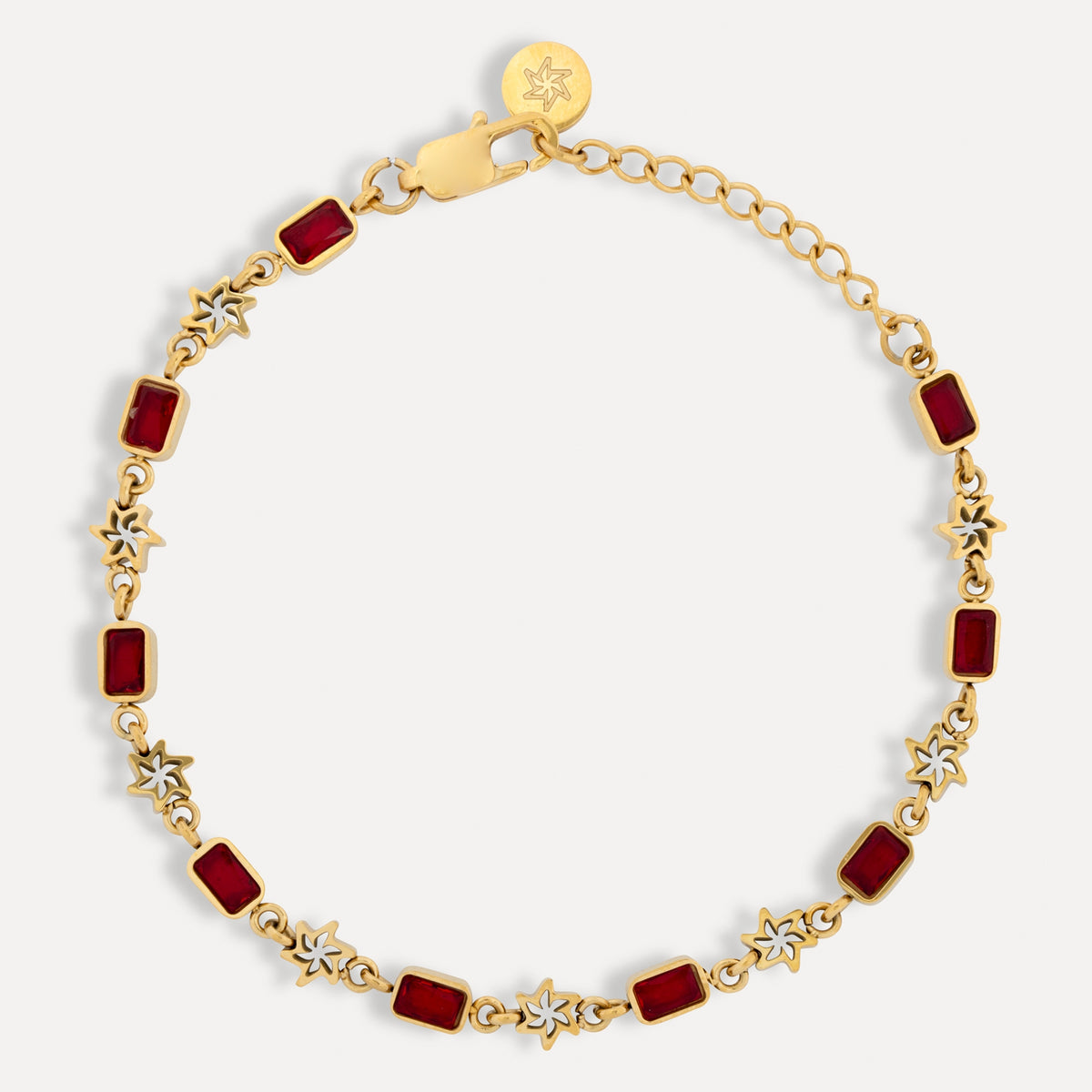 Gold bracelet with red square stones on a white background