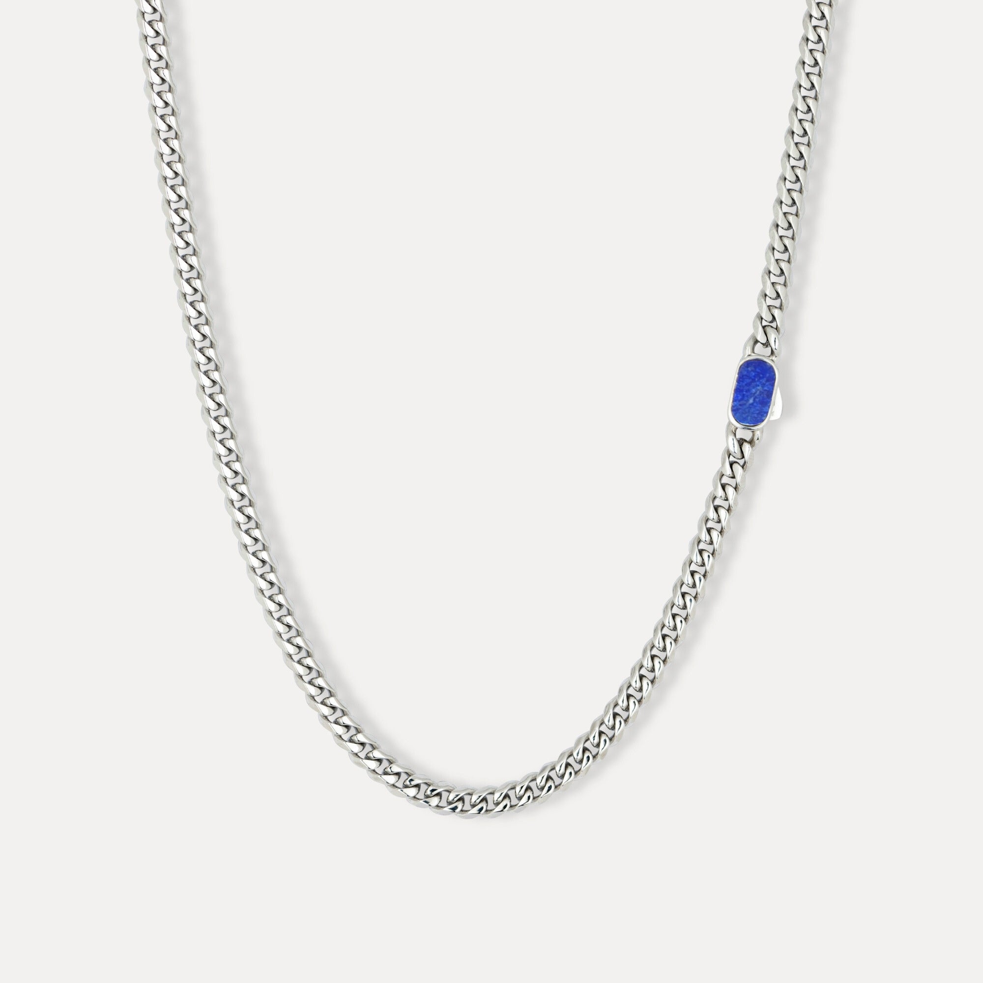 Silver chain necklace with a blue stone on a white background
