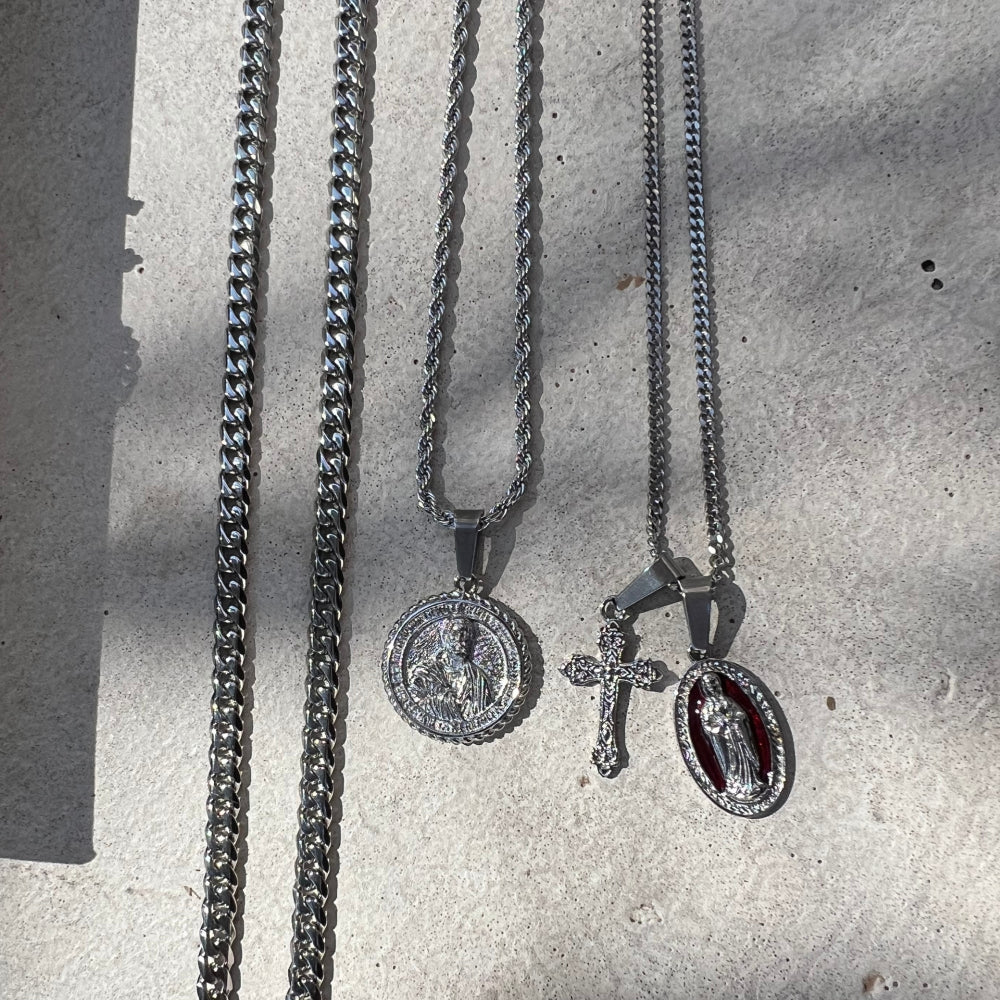 Three necklaces with pendants on a textured surface