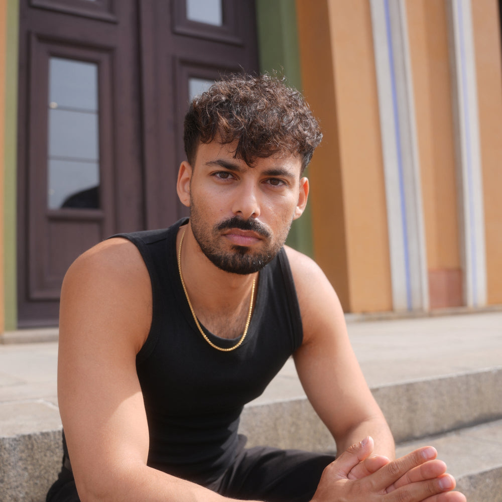 Man sitting on steps in front of a colorful building