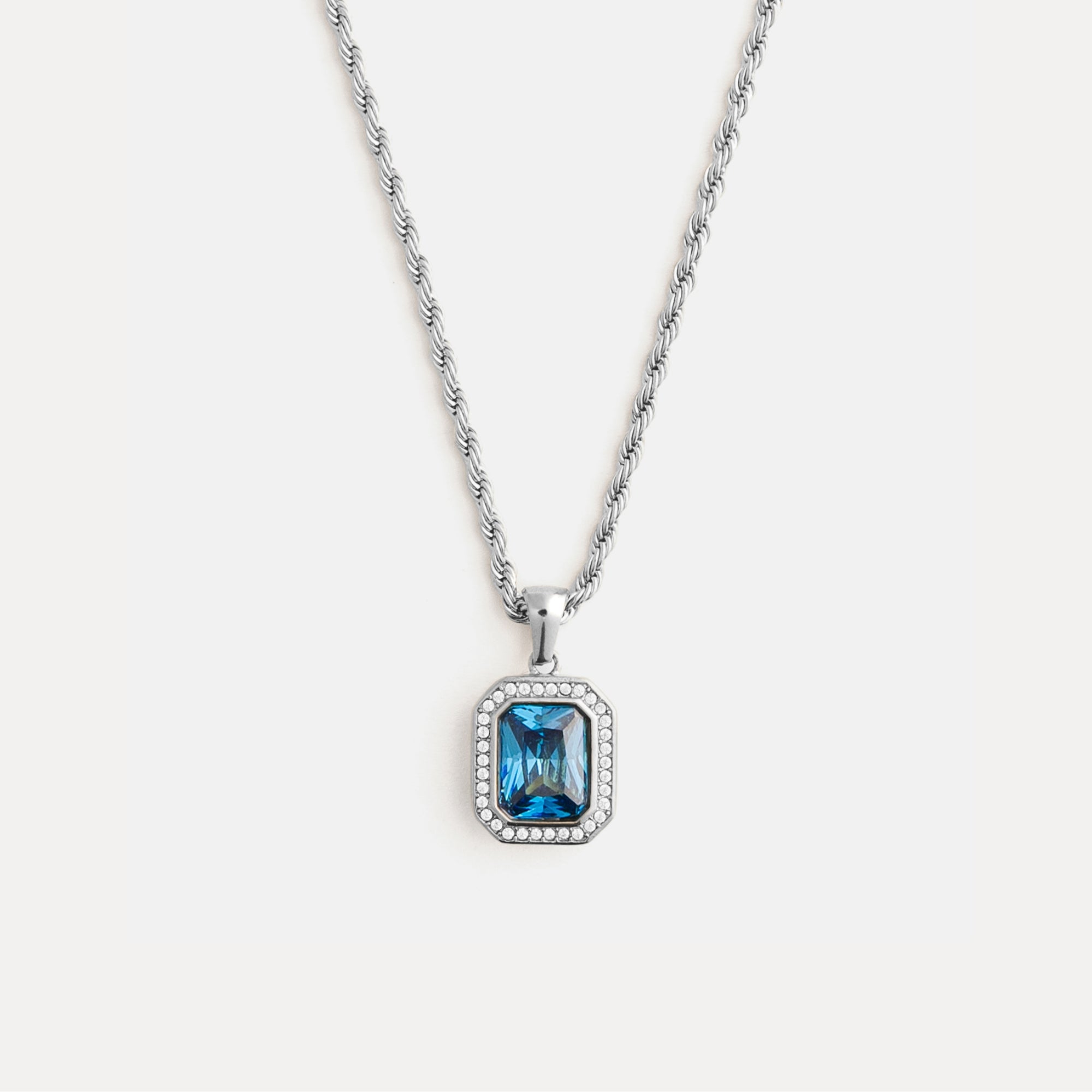 Necklace with a blue gemstone pendant on a white background