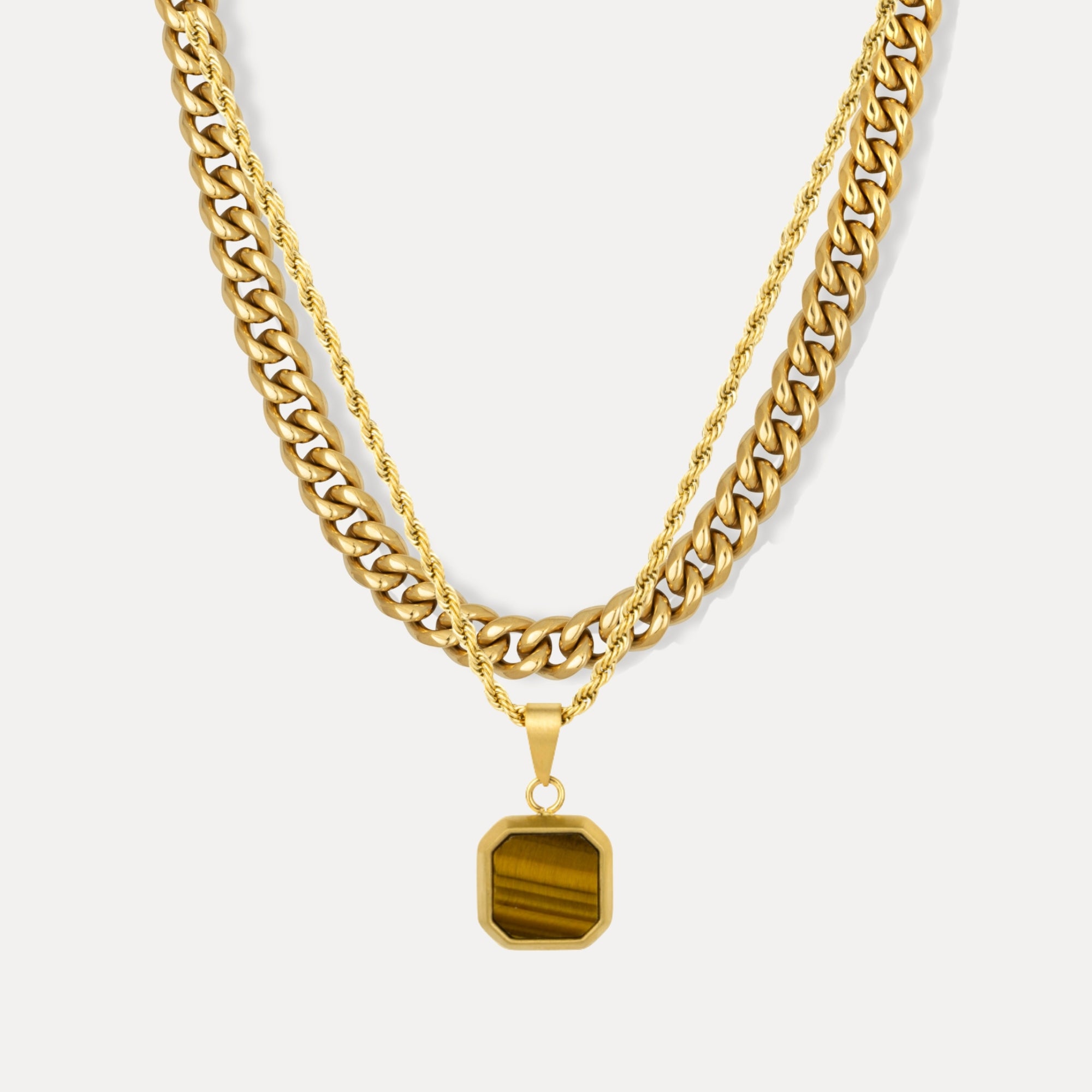 Gold chain necklace with a hexagonal pendant on a white background