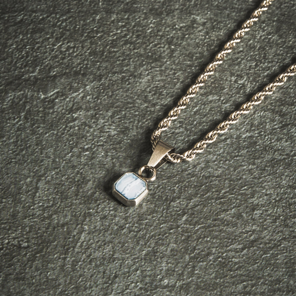 Necklace with a pendant on a dark textured surface