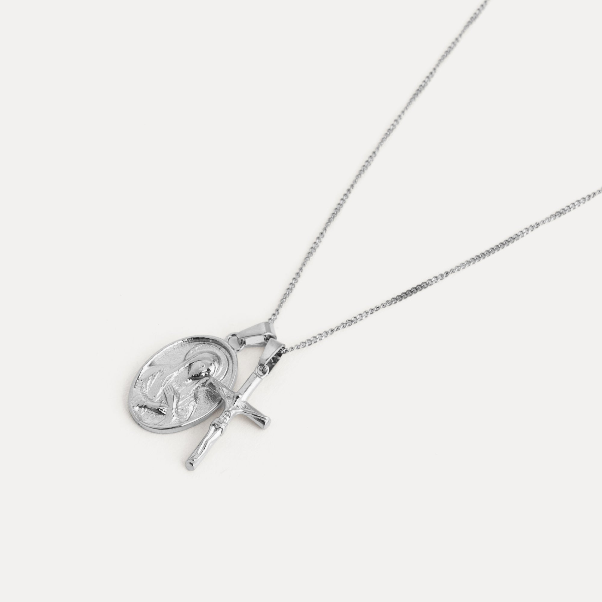 Silver necklace with a circular pendant on a white background