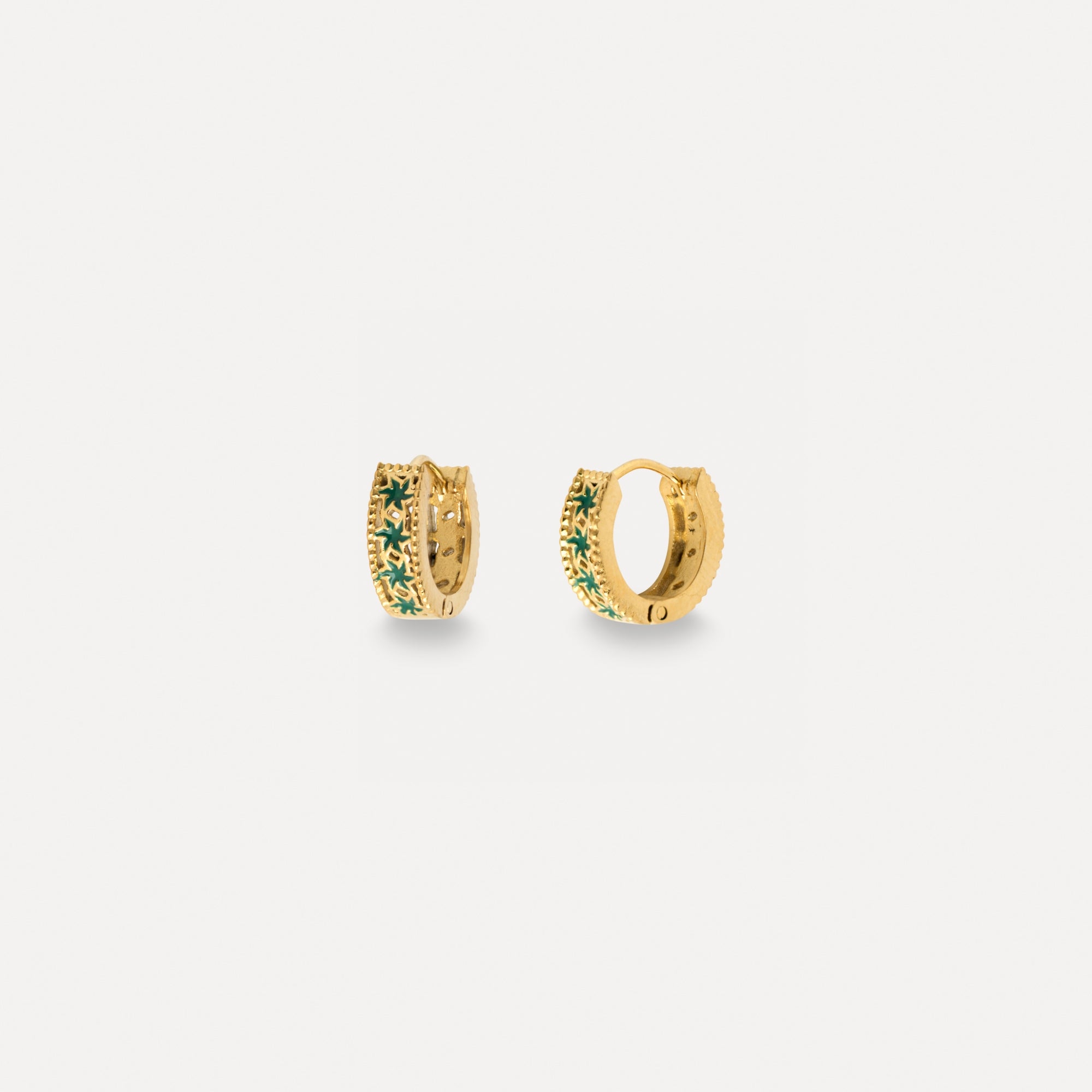Gold hoop earrings with green gemstones on a white background