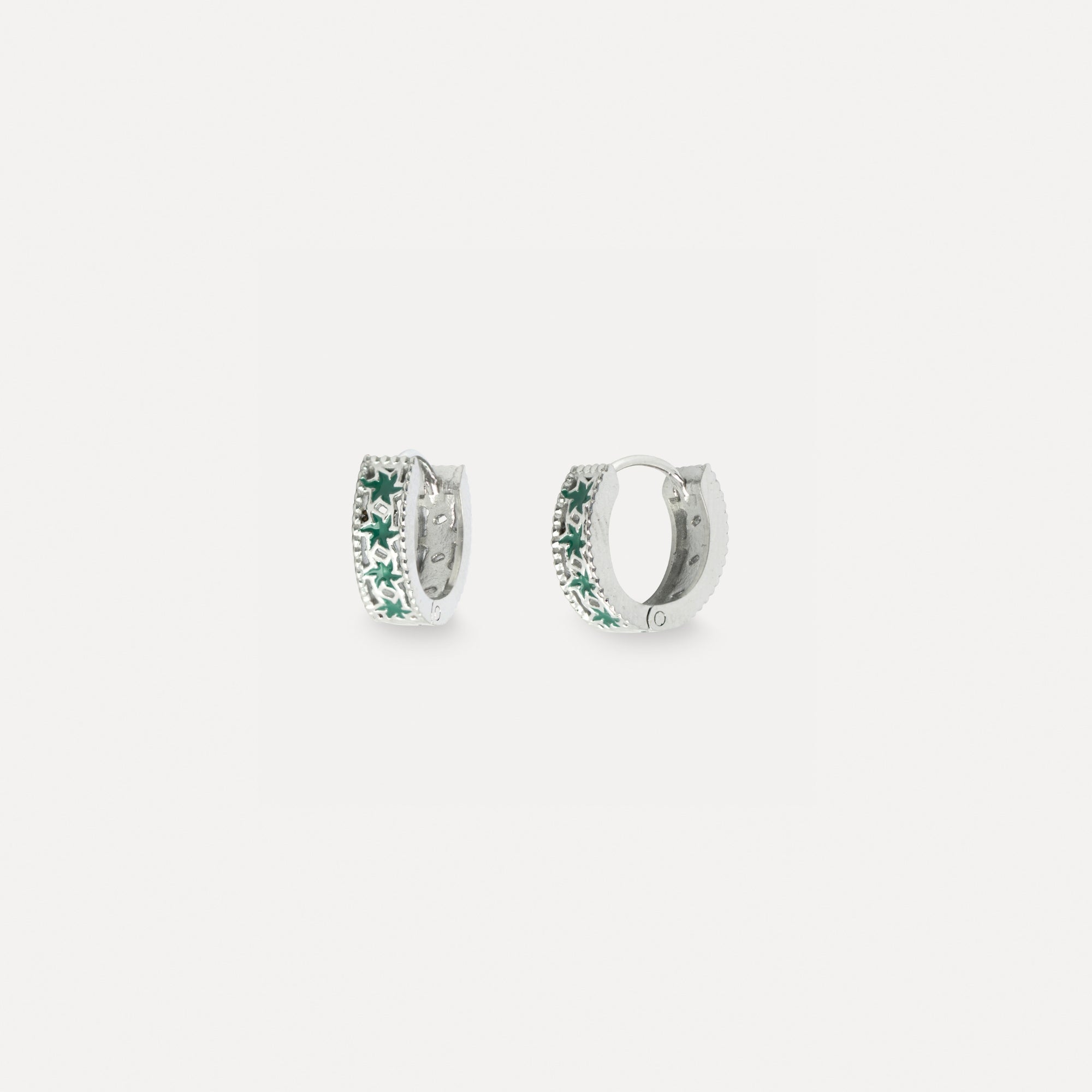 Pair of silver hoop earrings with green gemstones on a white background