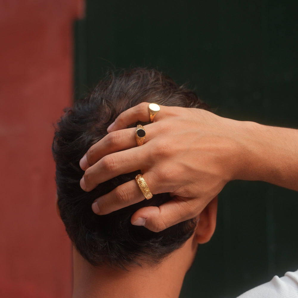 Hand with gold rings on a blurred background