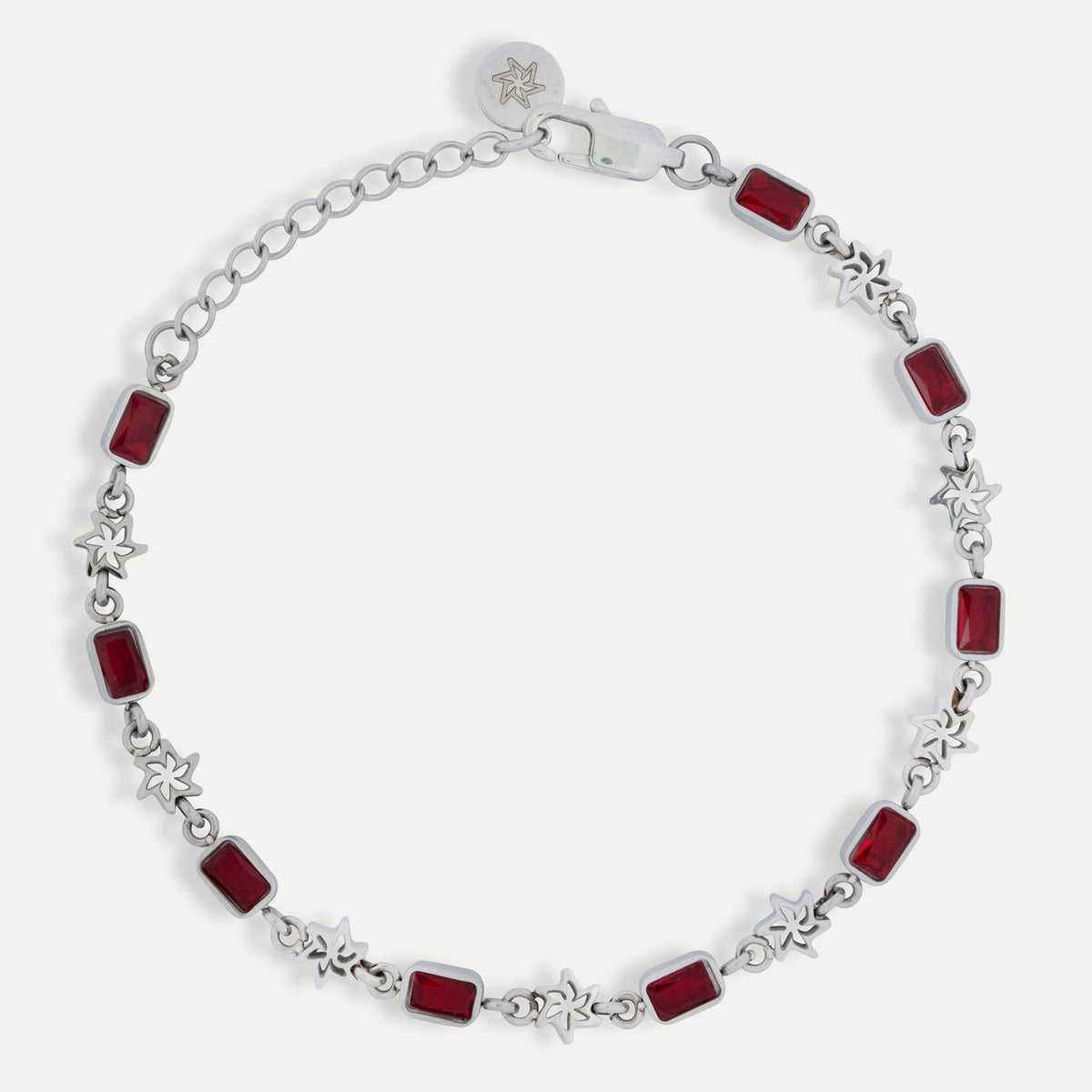 Silver bracelet with red square stones on a white background