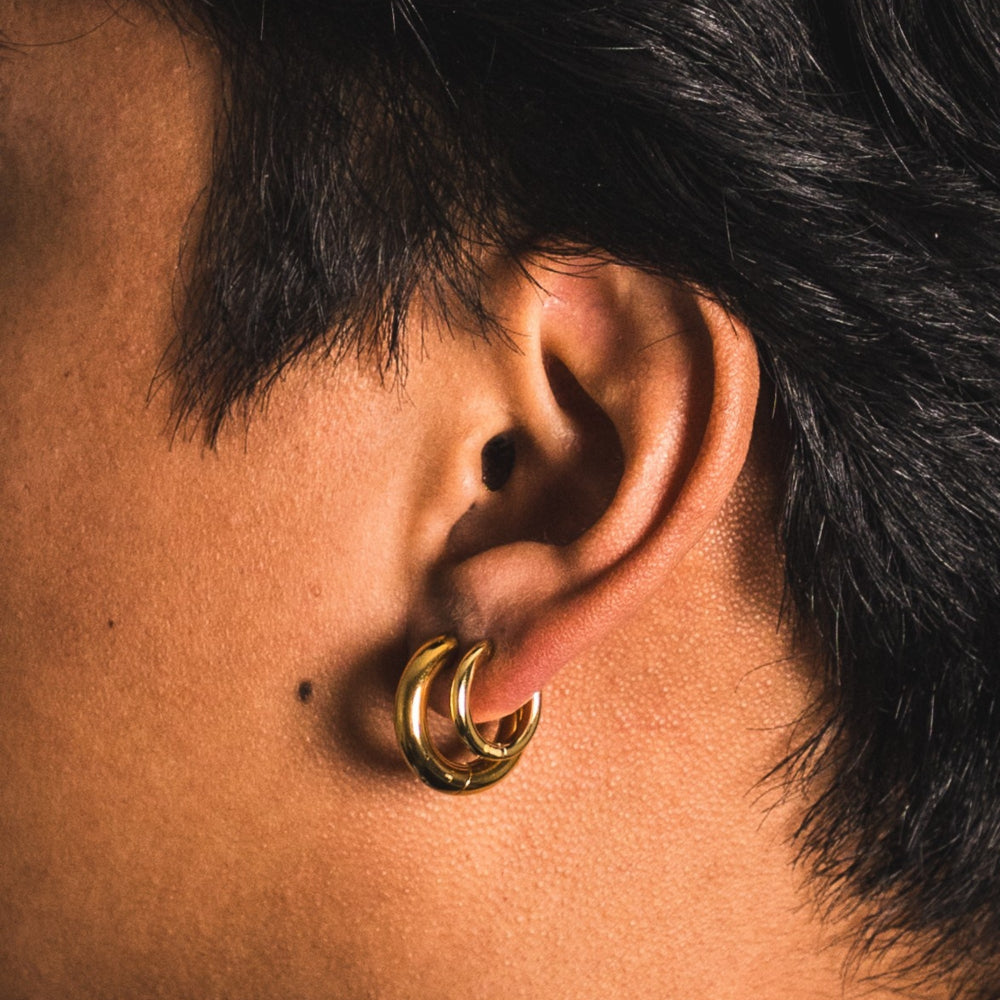 Close-up of an ear with a gold hoop earring
