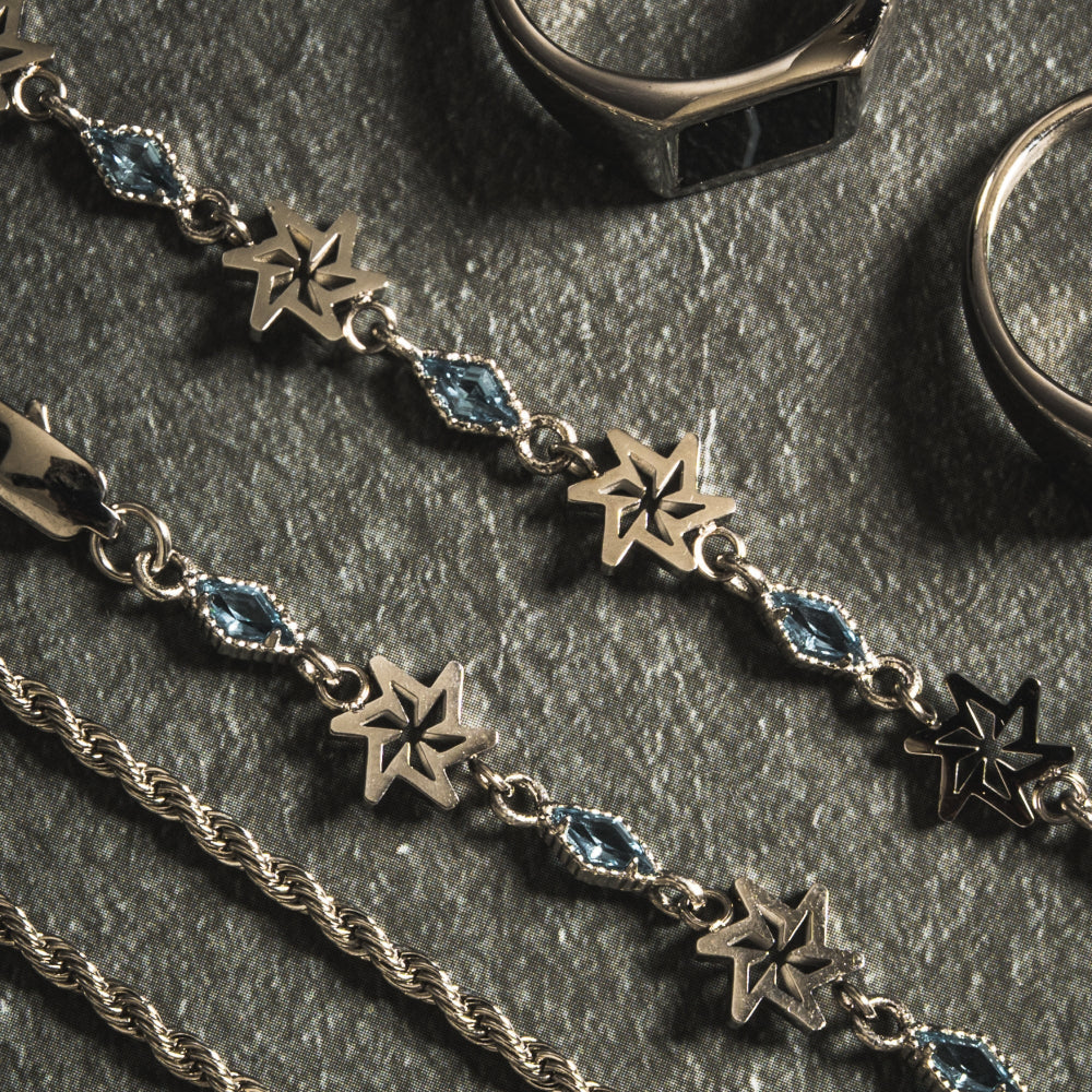 Silver star-shaped jewelry on a dark surface