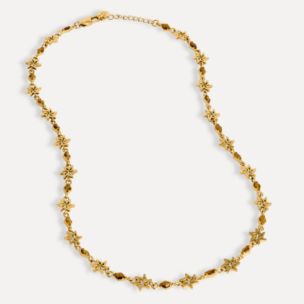 Gold necklace with floral designs on a white background