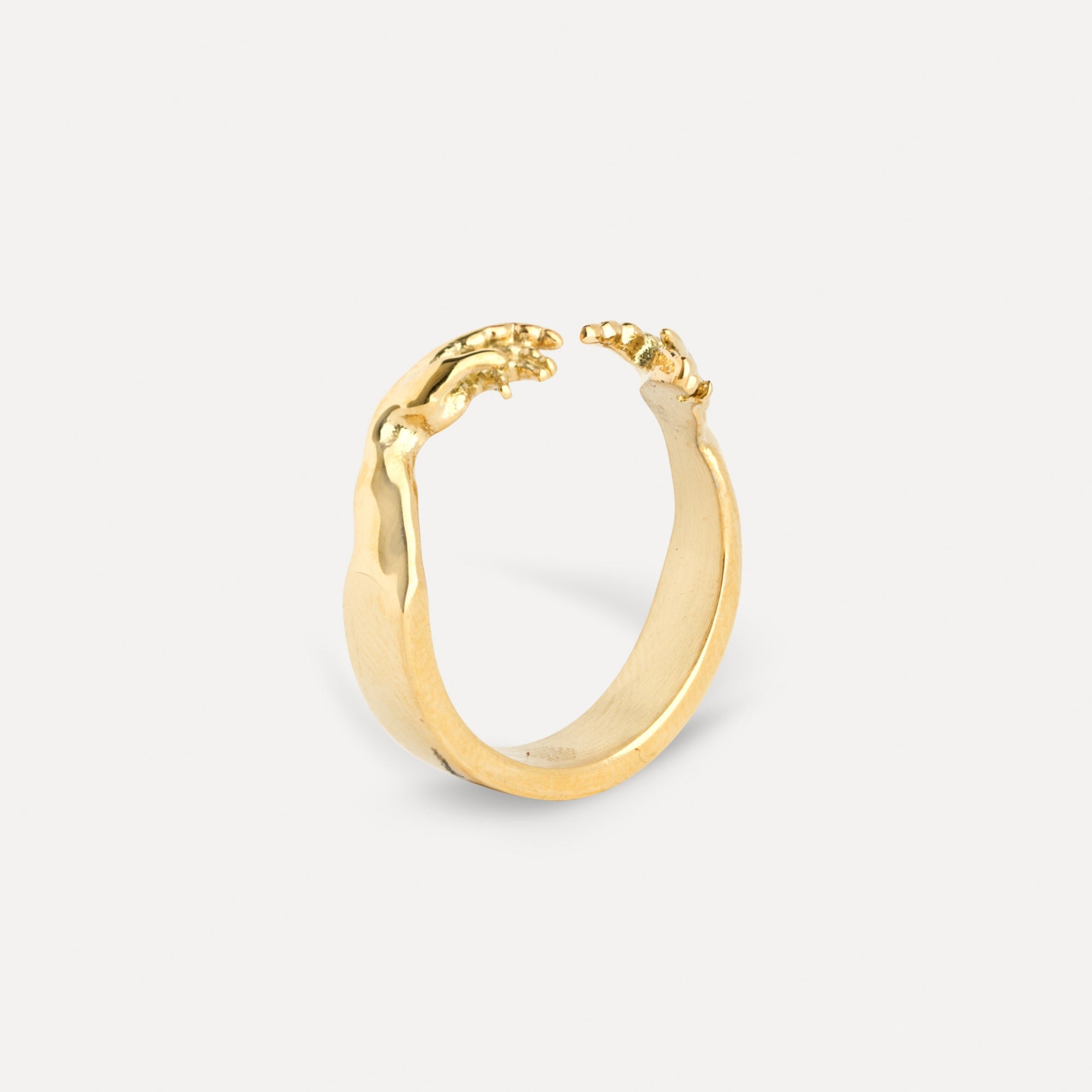 Gold hoop earring on a light gray background