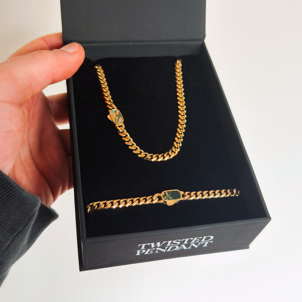 Gold chain with a pendant in a black box labeled 'Twisted Pendant'.