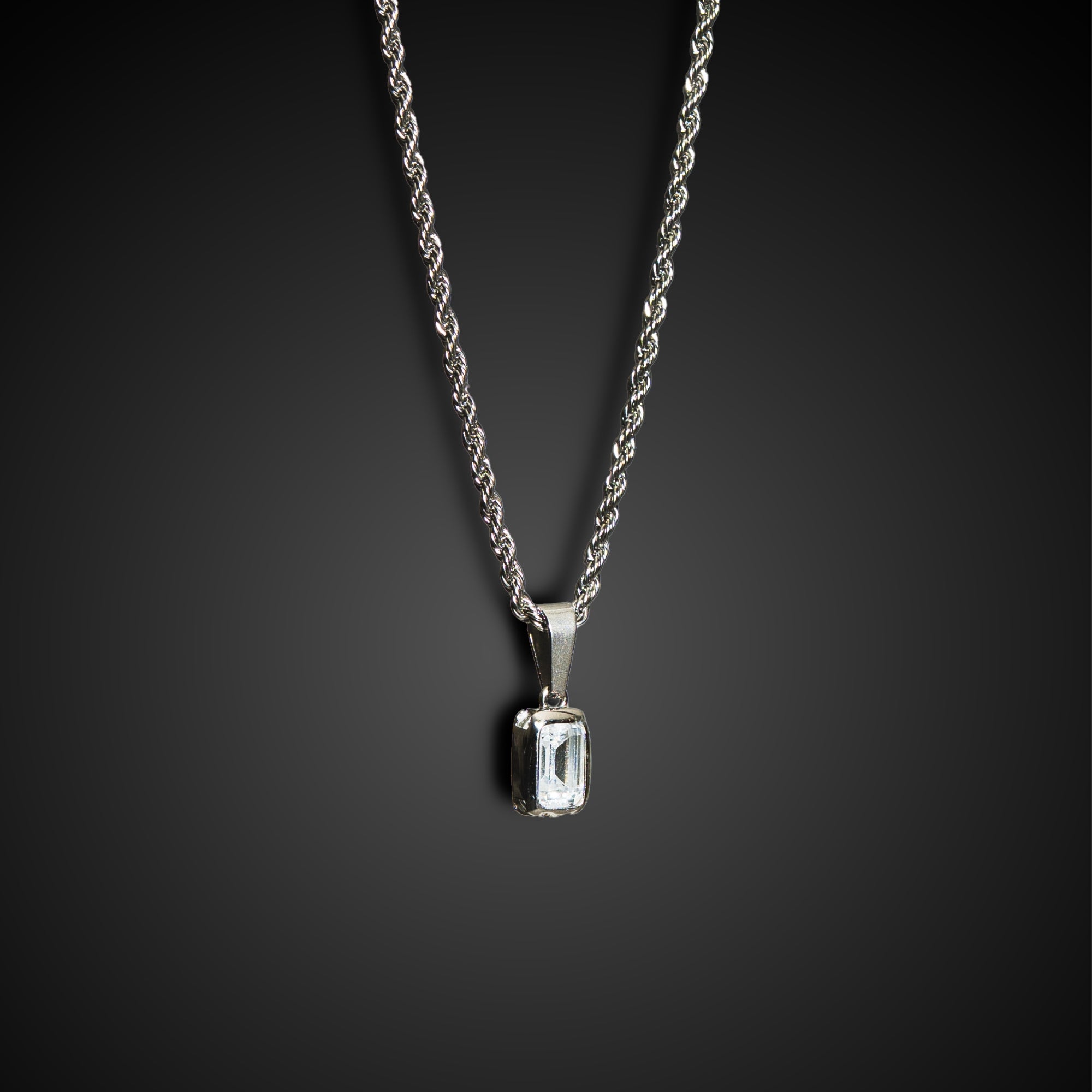 Silver necklace with a pendant on a dark background