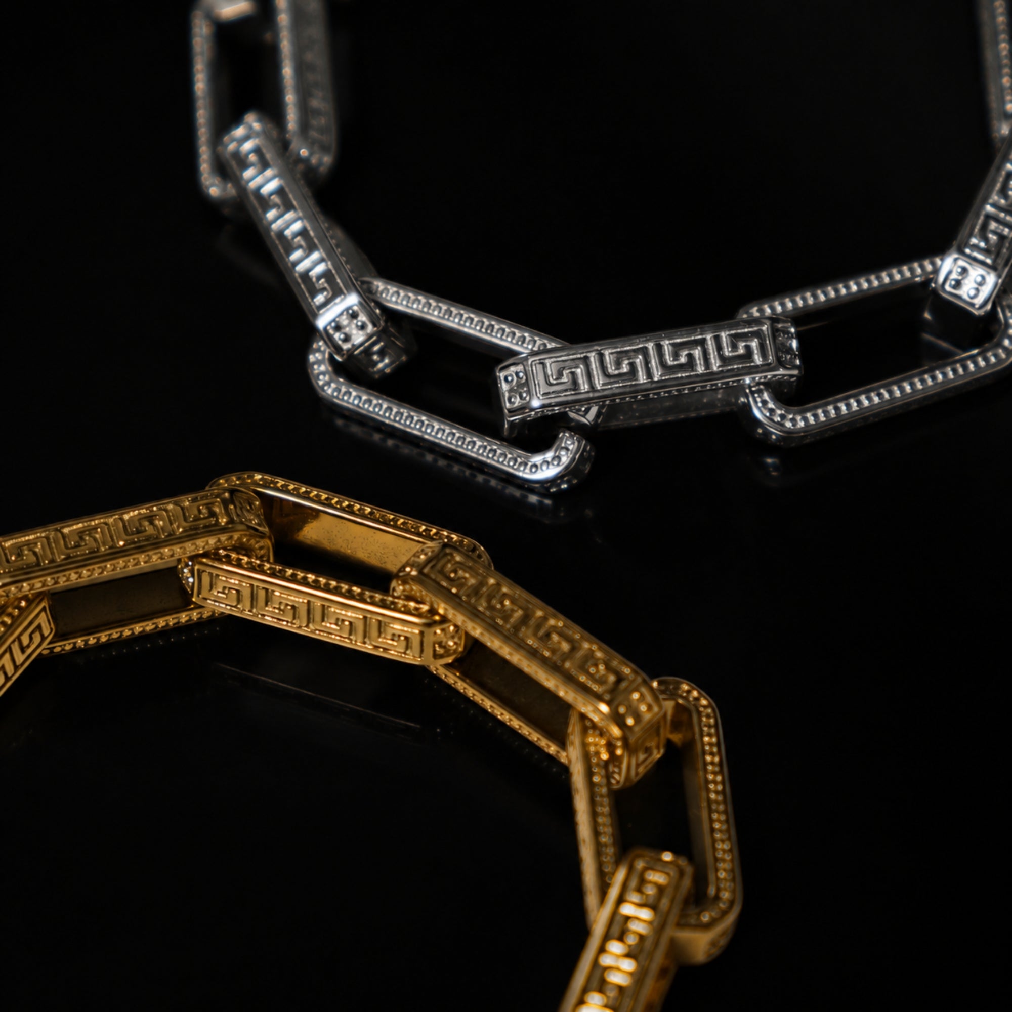 Gold and silver chain necklaces on a black background
