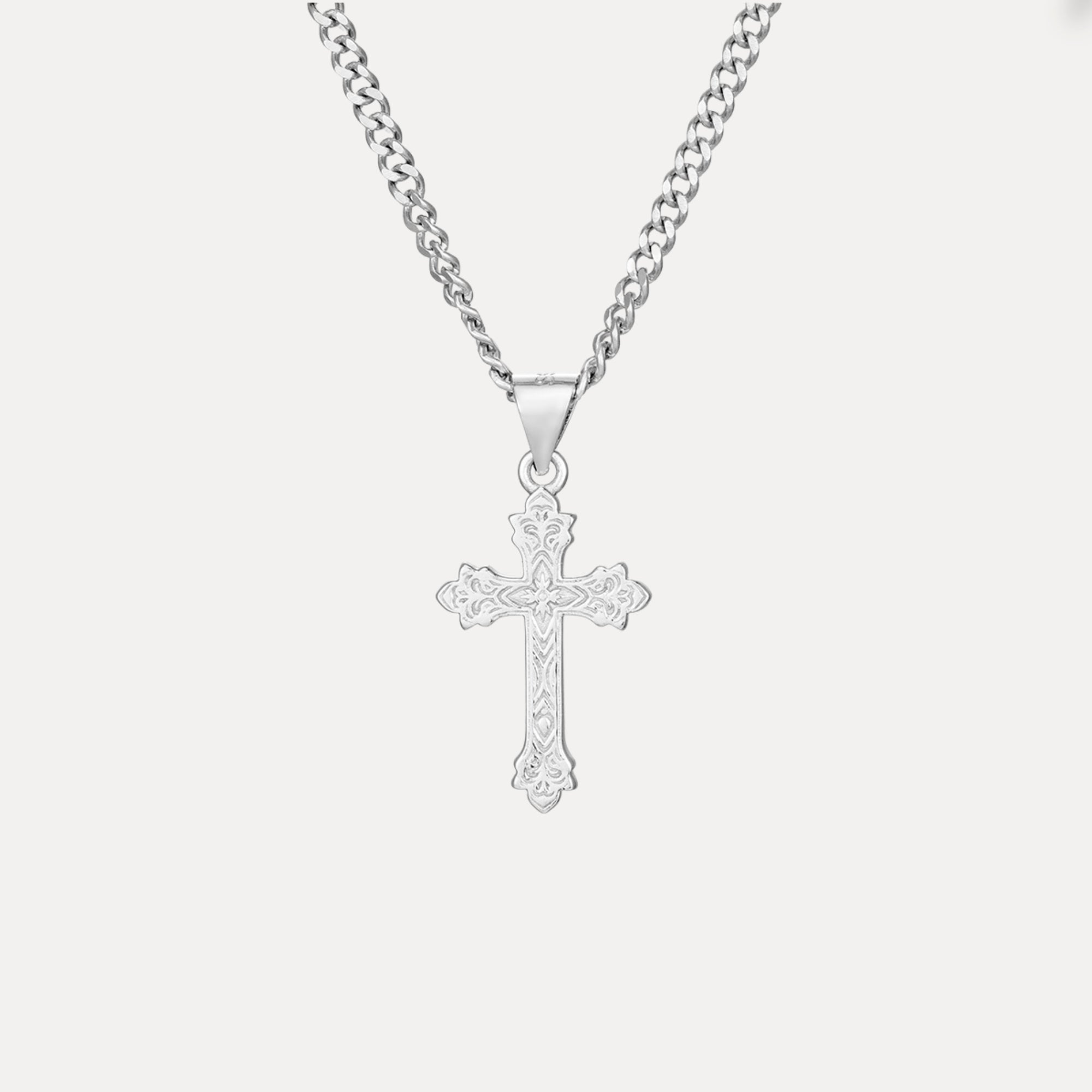 Silver cross pendant necklace on a white background