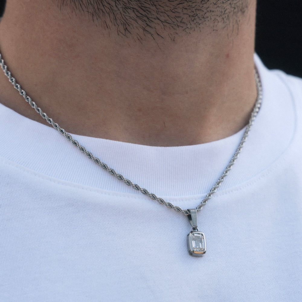 Necklace with a diamond pendant worn by a person on a white shirt