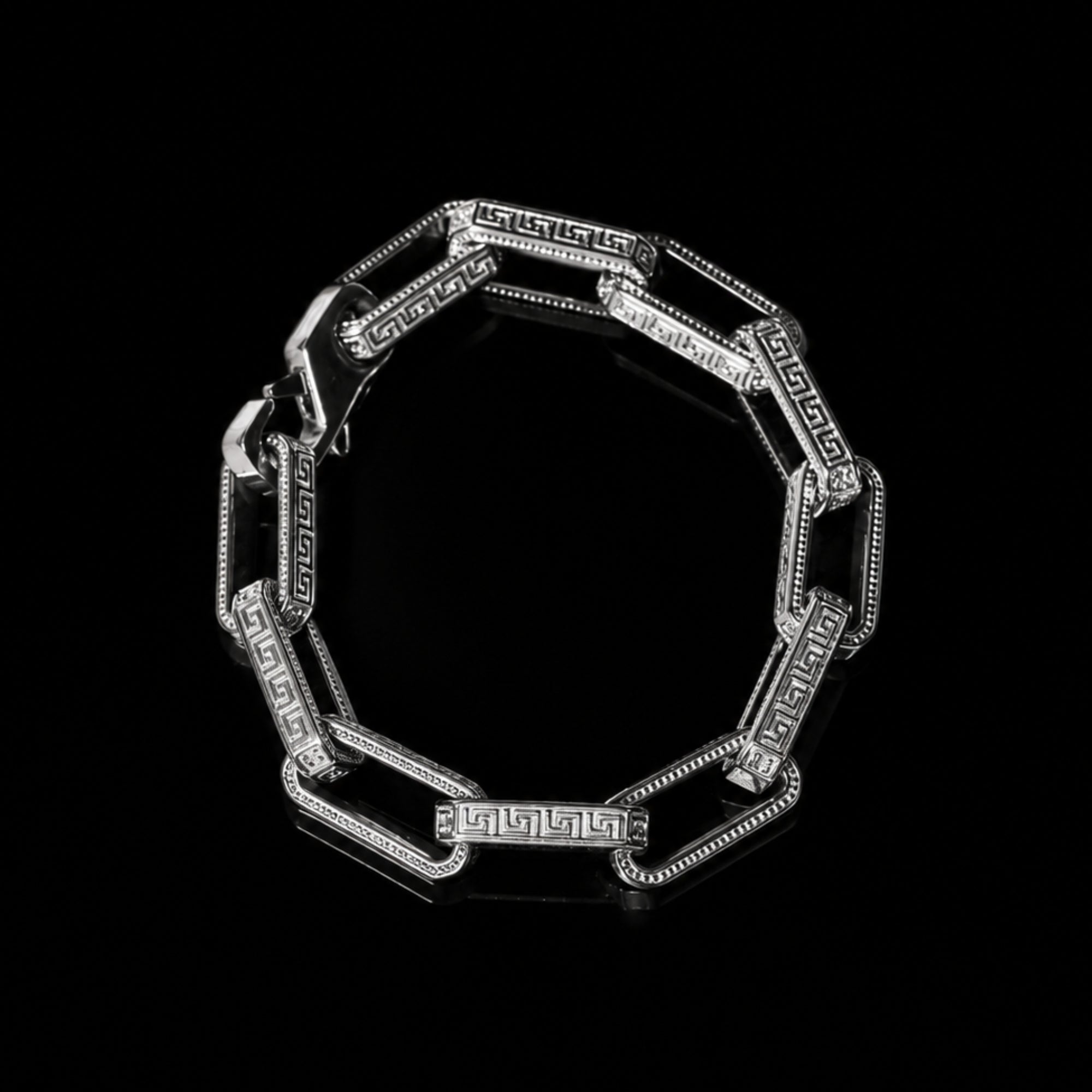Silver bracelet with intricate design on a black background