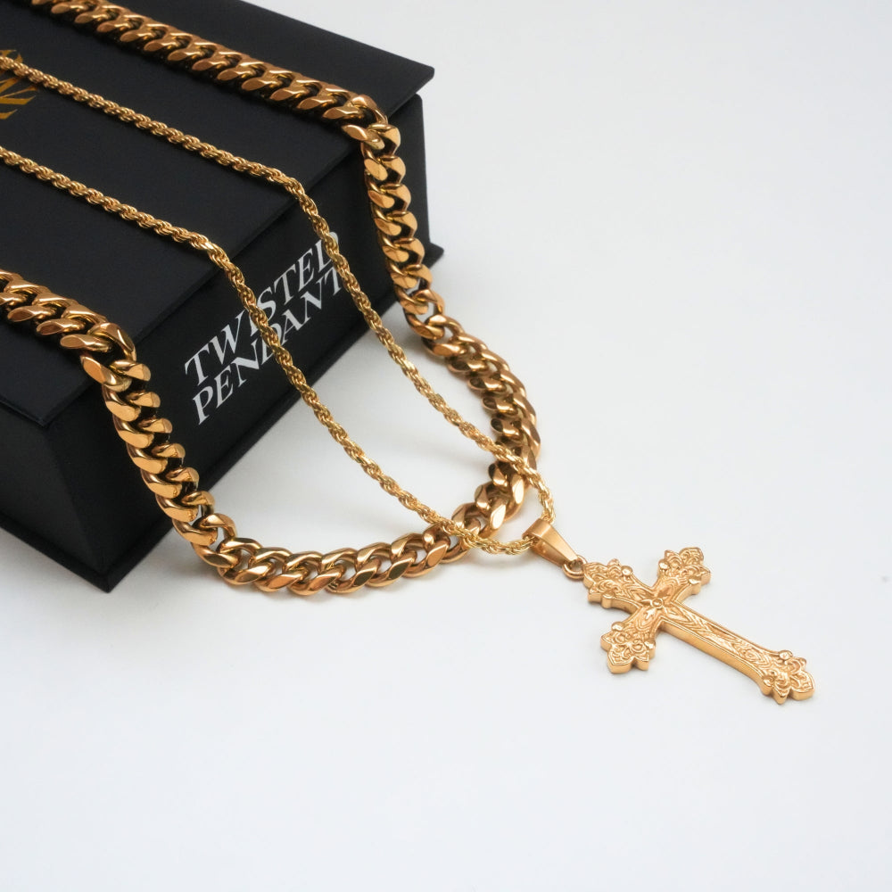 Gold chain necklace with a cross pendant on a white surface
