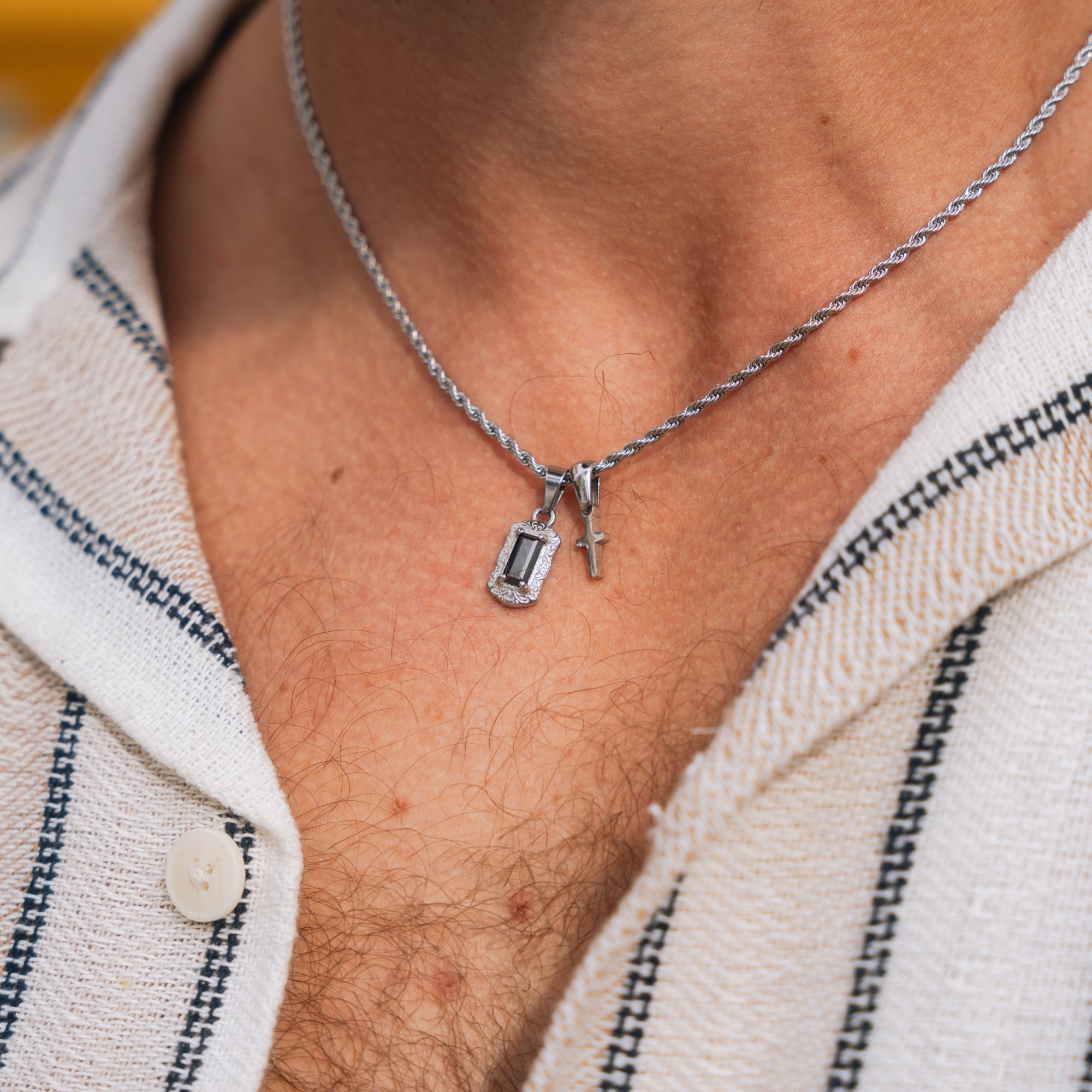 Necklace with a pendant worn by a person, close-up view.