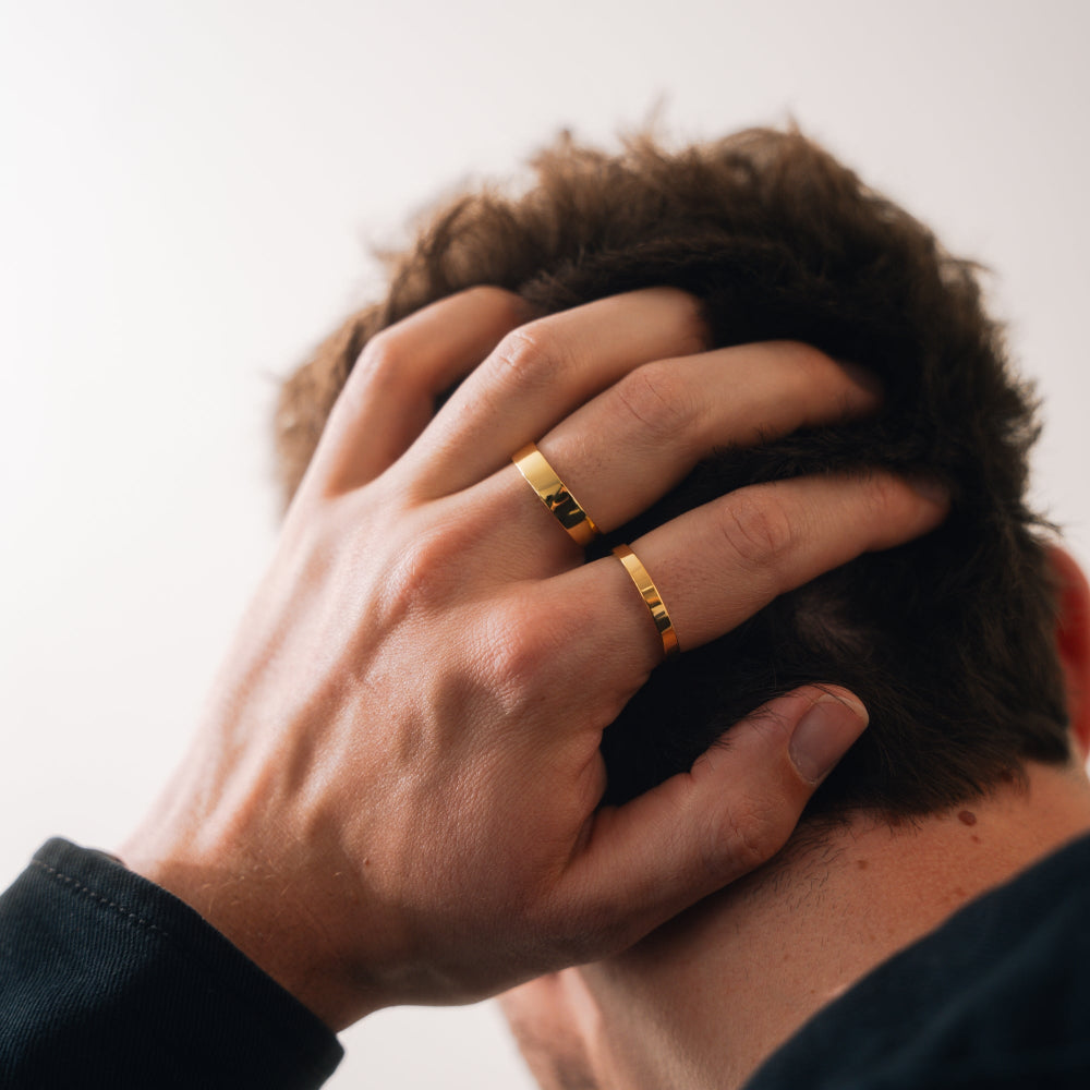 Hand with gold rings on a blurred background