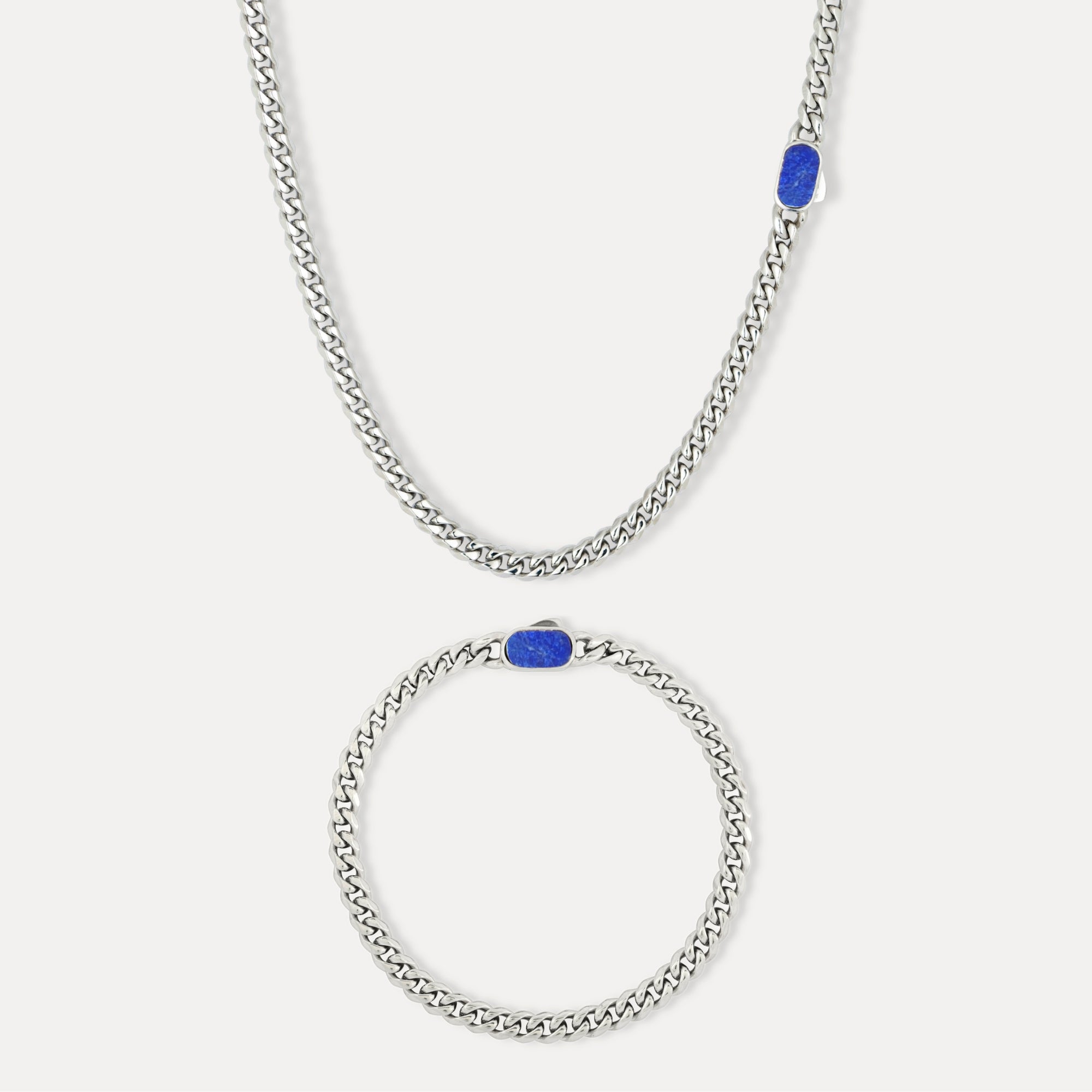 Silver chain necklace with blue stones on a white background
