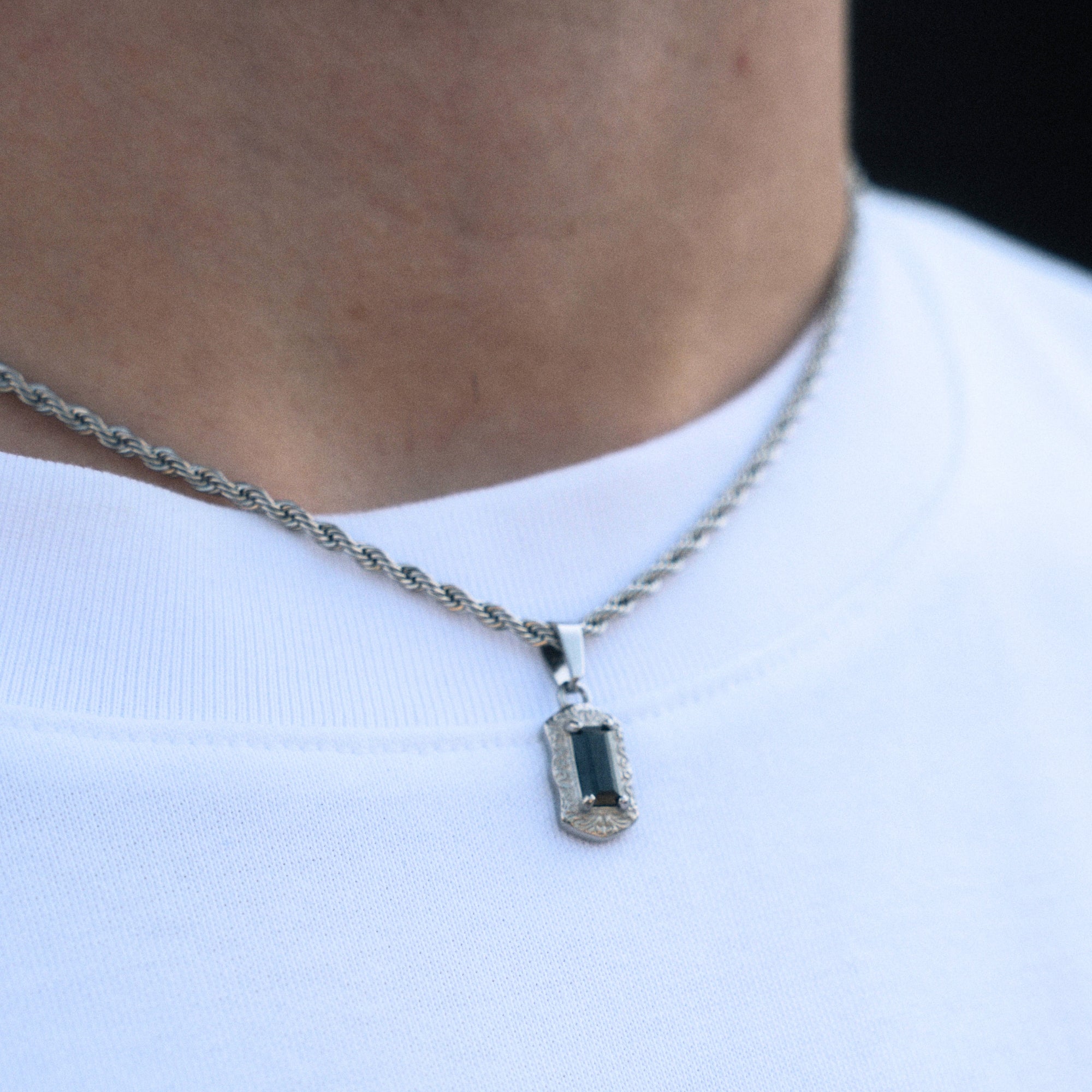Necklace with a pendant worn by a person on a white background
