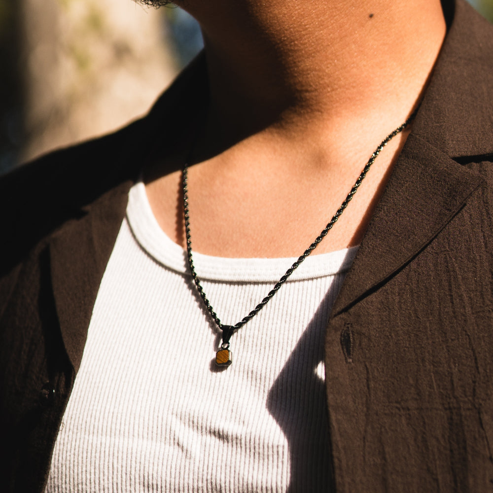Person wearing a necklace with a blurred background