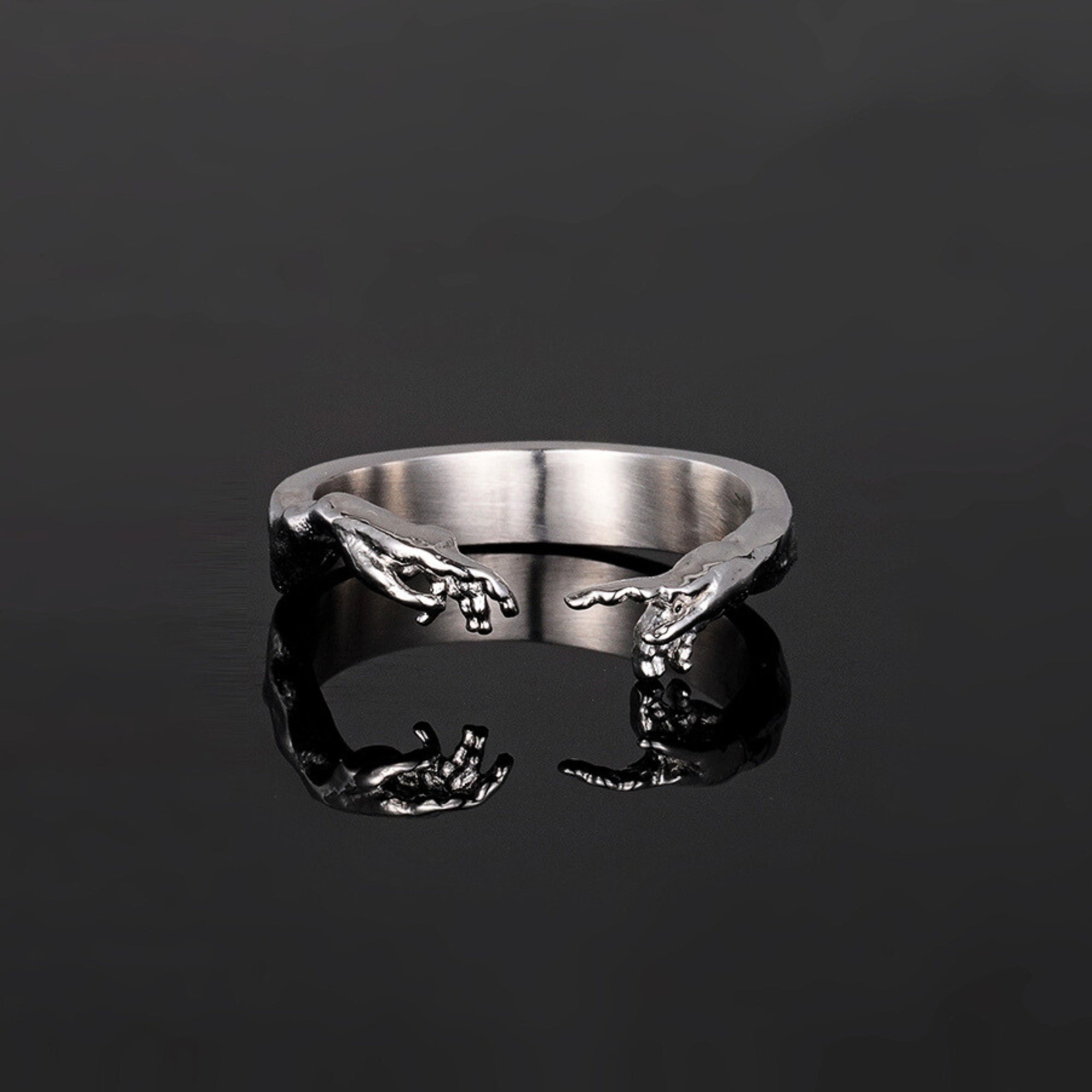 Silver ring with a unique design on a black background