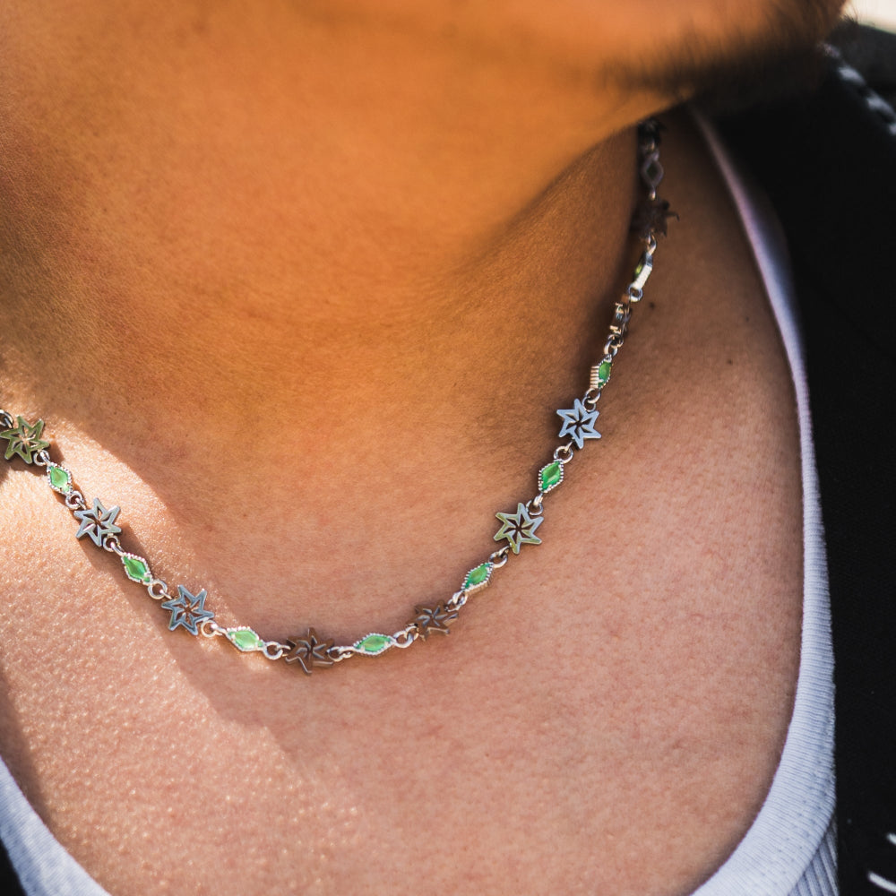 Necklace with star-shaped charms on a person's neck