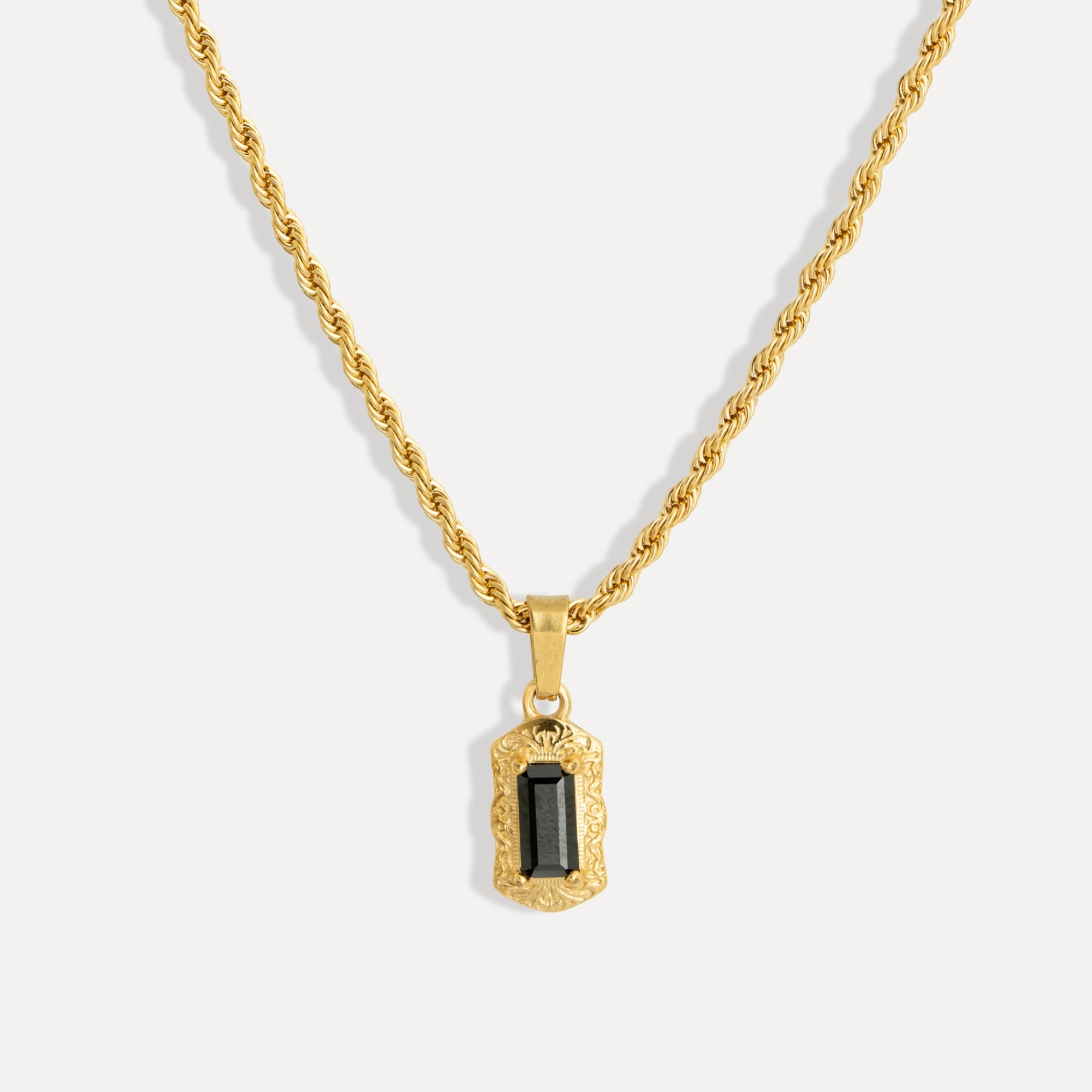 Gold necklace with a pendant on a white background