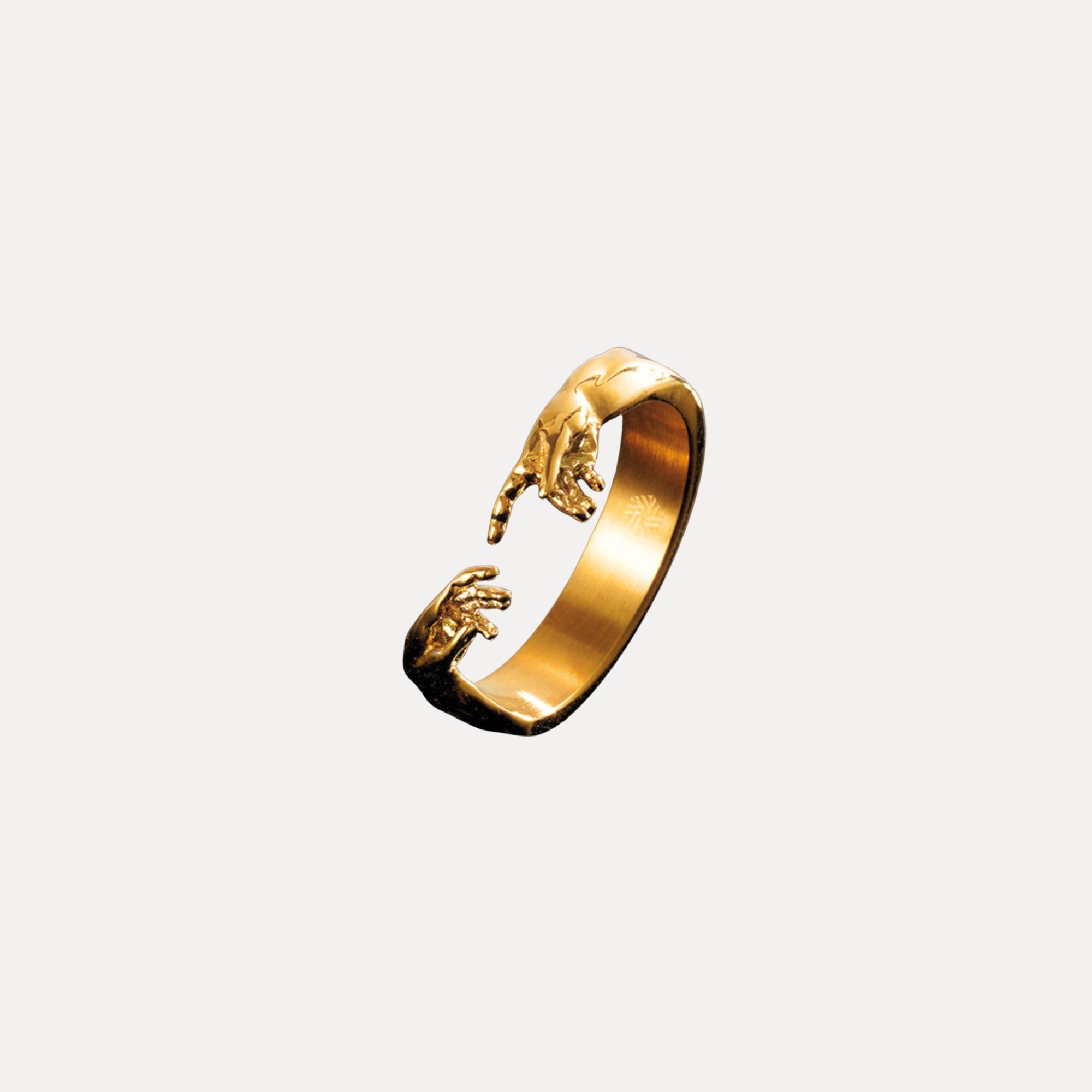 Gold ring with a unique design on a white background