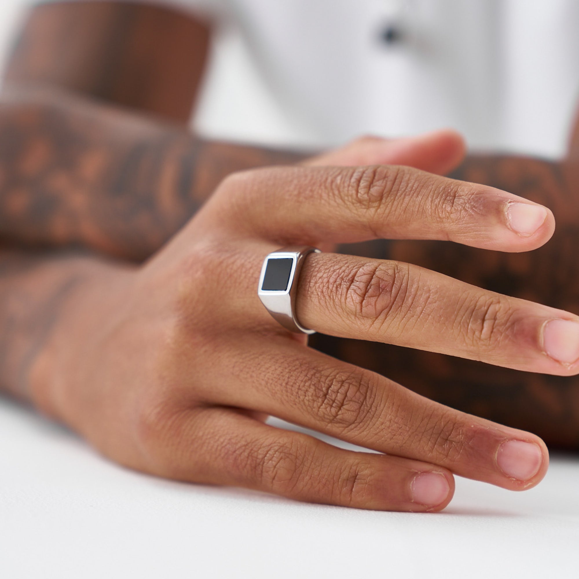Hand wearing a digital ring on a blurred background
