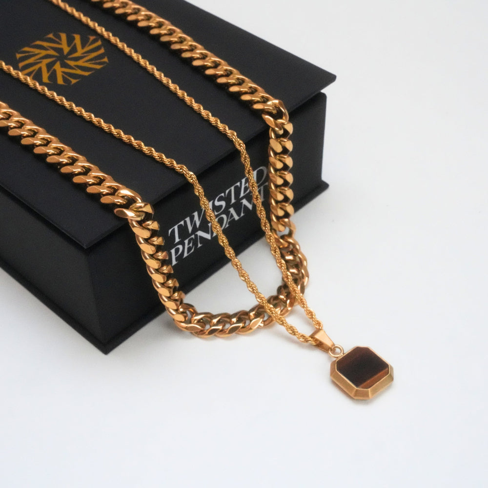 Gold chain necklace with a pendant on a black box labeled 'Twisted Pendant'.