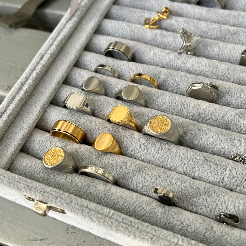 Collection of gold and silver rings in a jewelry box