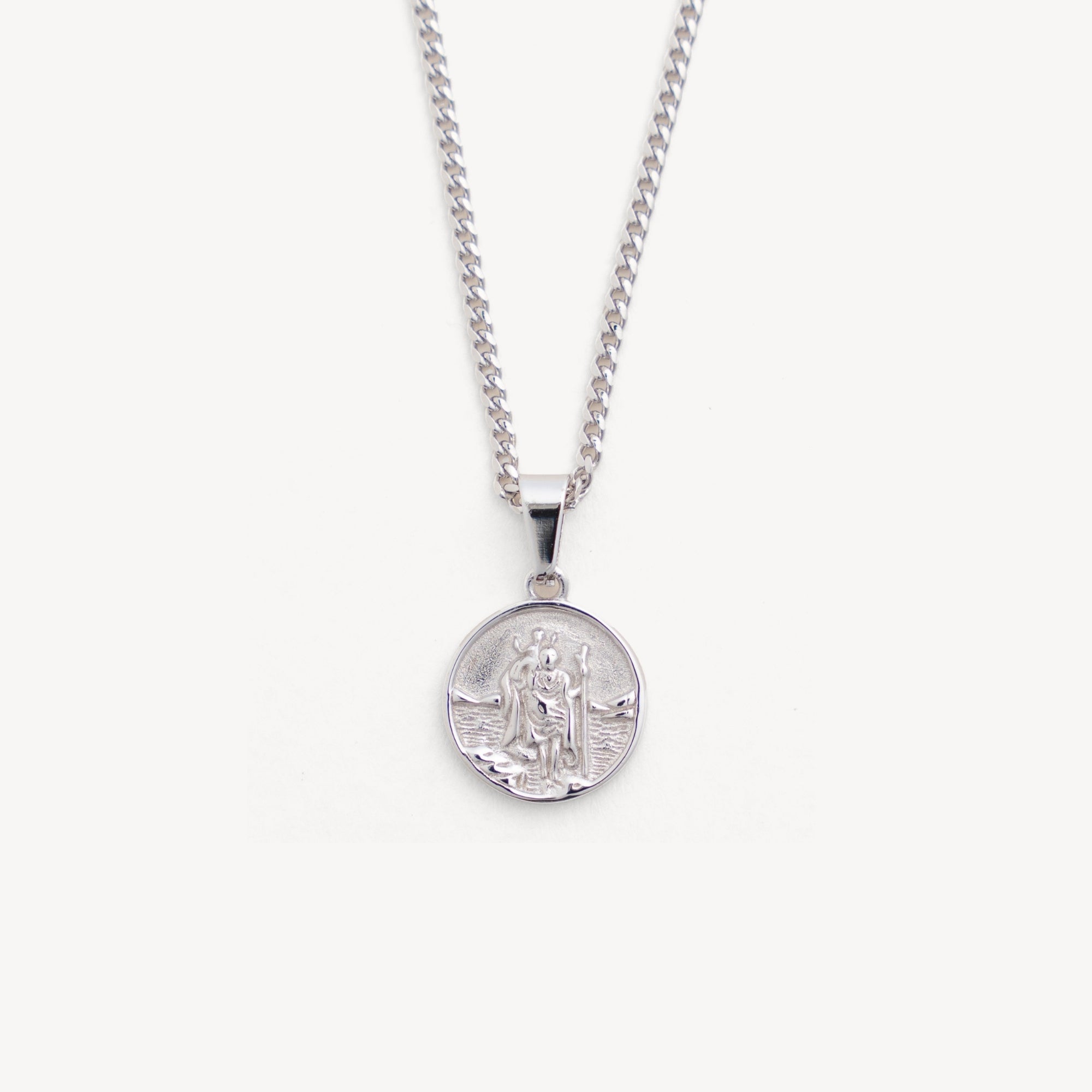 Silver necklace with a round pendant on a white background