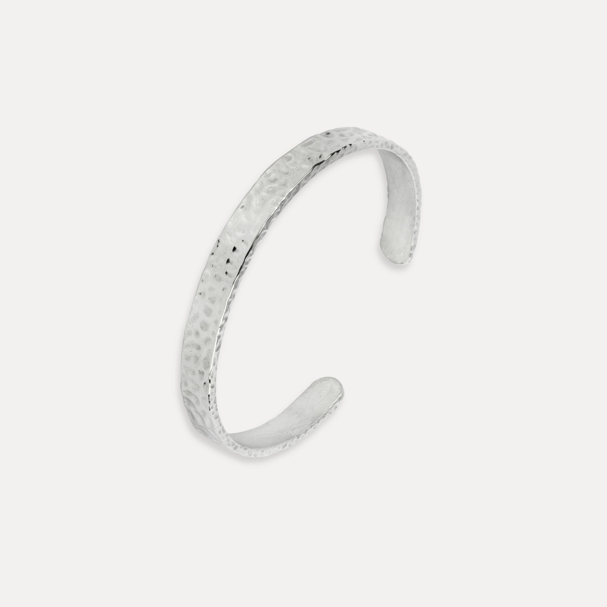 Silver bracelet on a light gray background